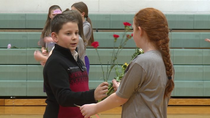 Boys hand out Valentine’s Day flowers to every girl at school