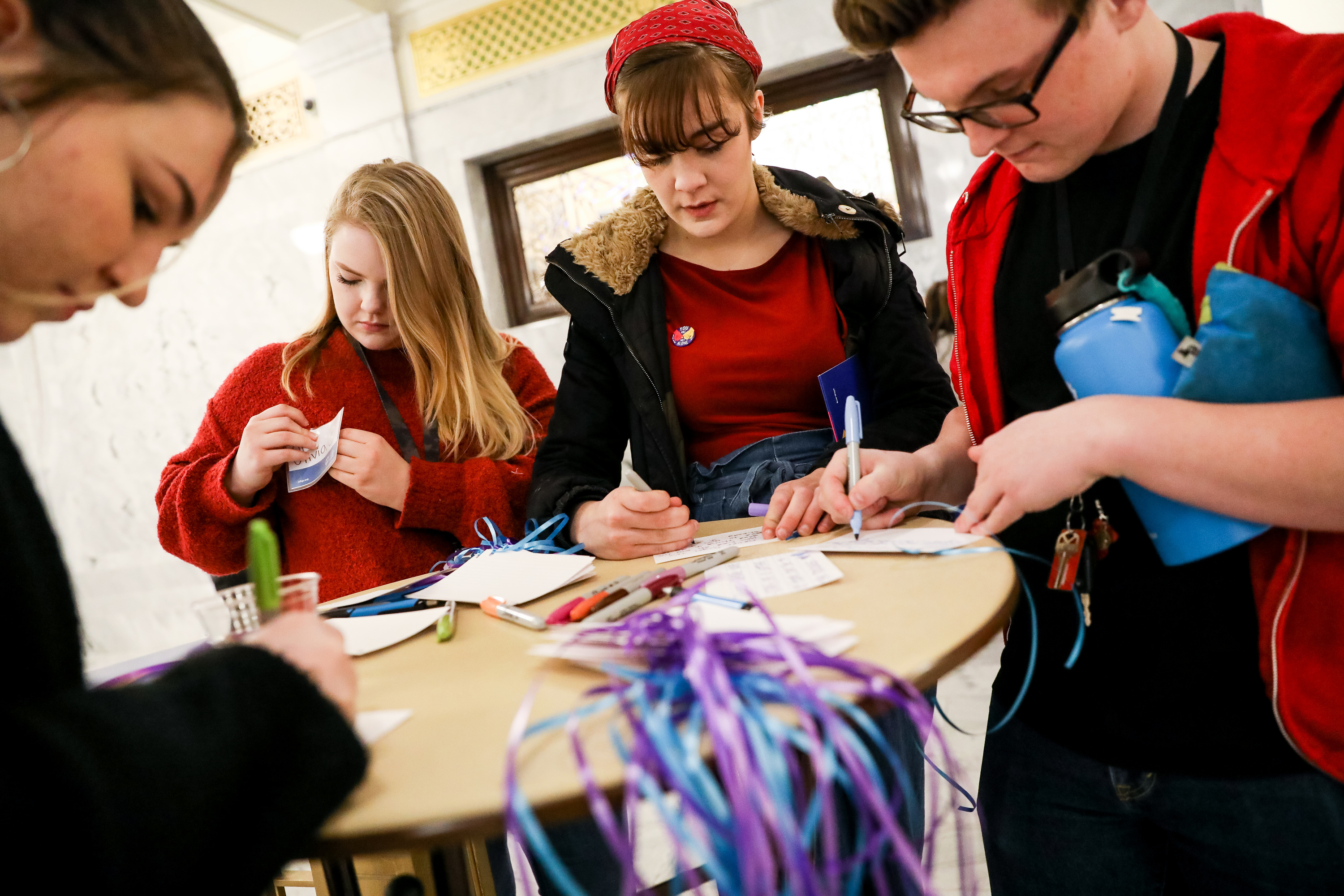 Tori Wood, 17, Olivia Warner, 18, Laurel Morgan, 17, and Theodore Housinger, 18, all students at the Salt Lake School for the Performing Arts, write remembrances and messages of hope on cards to be displayed as part of Suicide Prevention Day at the Capitol in Salt Lake City on Thursday, Feb. 13, 2020. (Spenser Heaps, KSL)