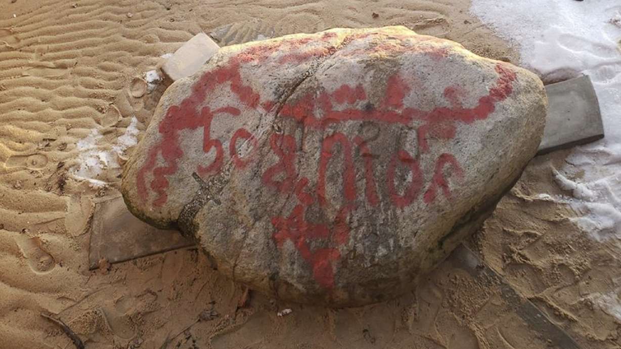 Vandals cover Plymouth Rock in red graffiti