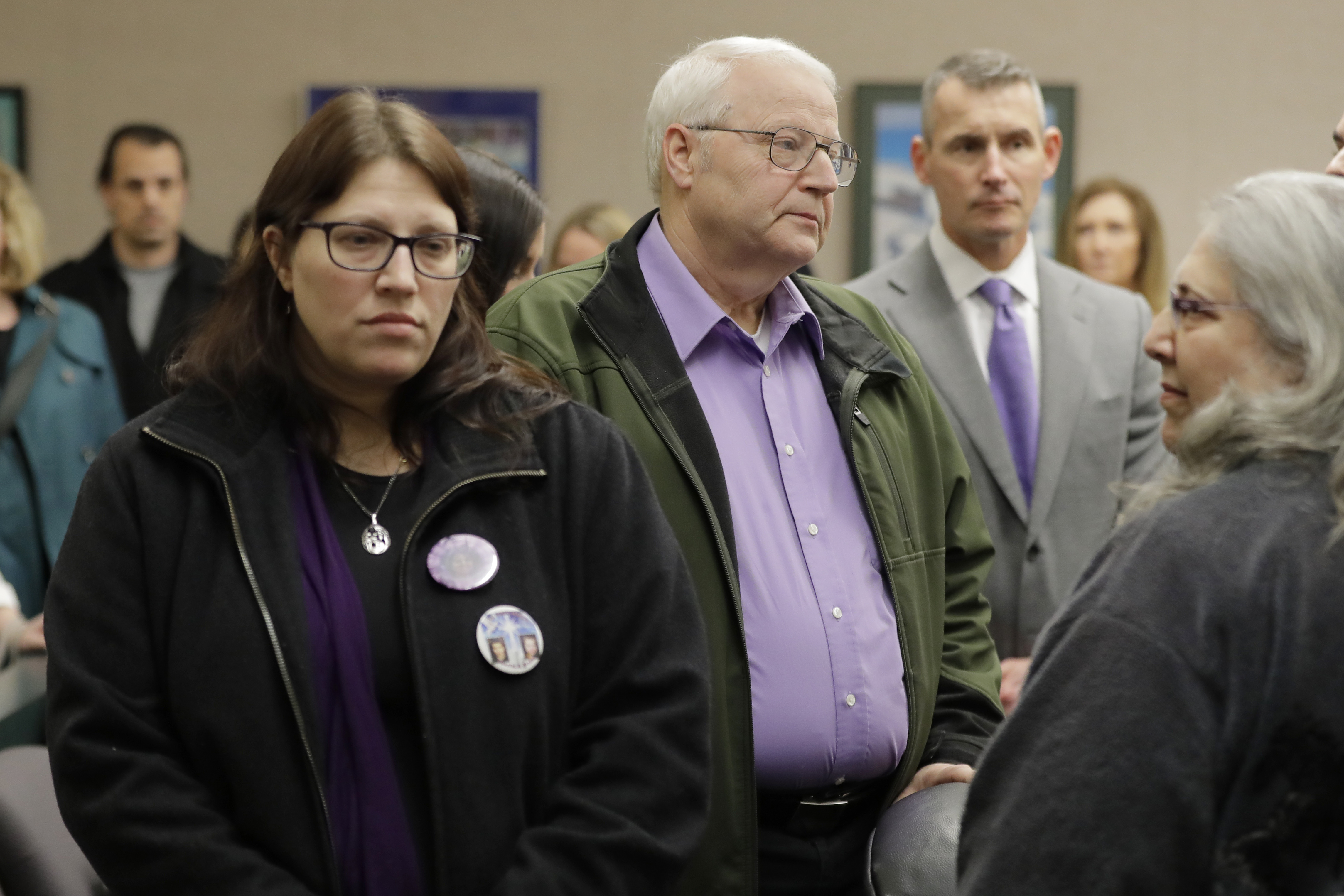 Chuck Cox, center, and his wife, Judy Cox, right, stand with their daughter, Denise Ernest, left, and their attorney, Ted Buck, second from right, Tuesday, Feb. 18, 2020, during a break in a session of Pierce County Superior Court in Tacoma, Wash., on the first day of a civil lawsuit over the murder of the Cox's young grandsons. (Ted S. Warren, AP Photo)