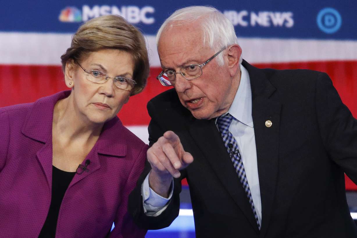 Democratic presidential candidates, Sen. Elizabeth Warren, D-Mass., left, and Sen. Bernie Sanders, I-Vt., talk during a Democratic presidential primary debate Wednesday, Feb. 19, 2020, in Las Vegas, hosted by NBC News and MSNBC. (John Locher, AP Photo)