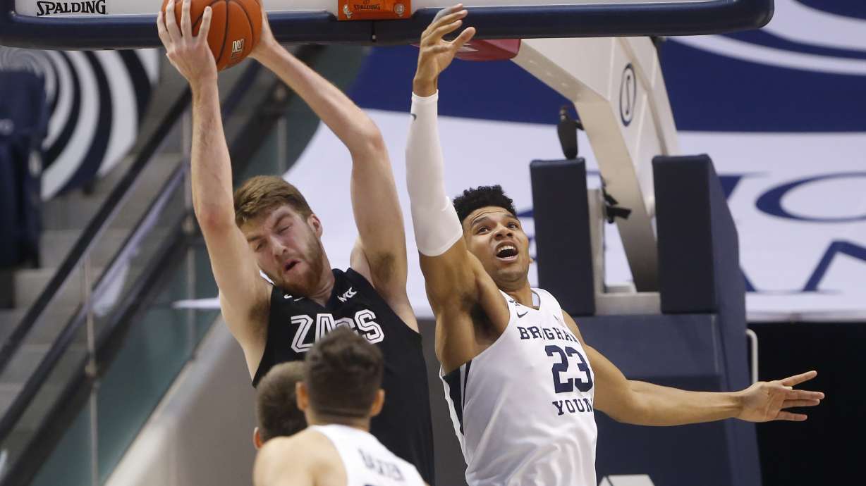 Gonzaga forward Drew Timme, left rear, grabs a rebound as BYU forward Yoeli Childs (23) reaches for it during the first half of an NCAA college basketball game, Feb. 22, 2020, in Provo. The Salt Lake City stars acquired the G League rights to Childs in a trade Thursday with the Capital City Go-Go.