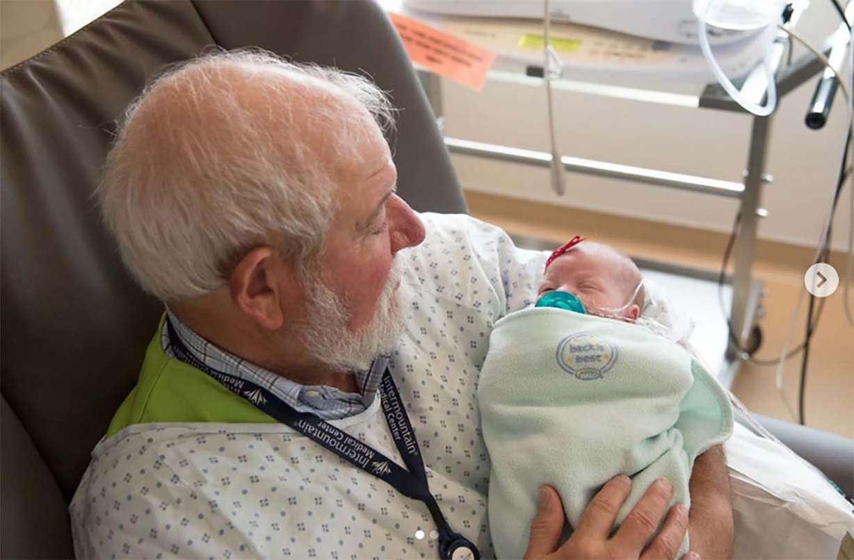 Volunteer Craig Provost, holds a NICU baby at Intermountain Medical Center. Photo: Courtesy Intermountain via KSL NewsRadio