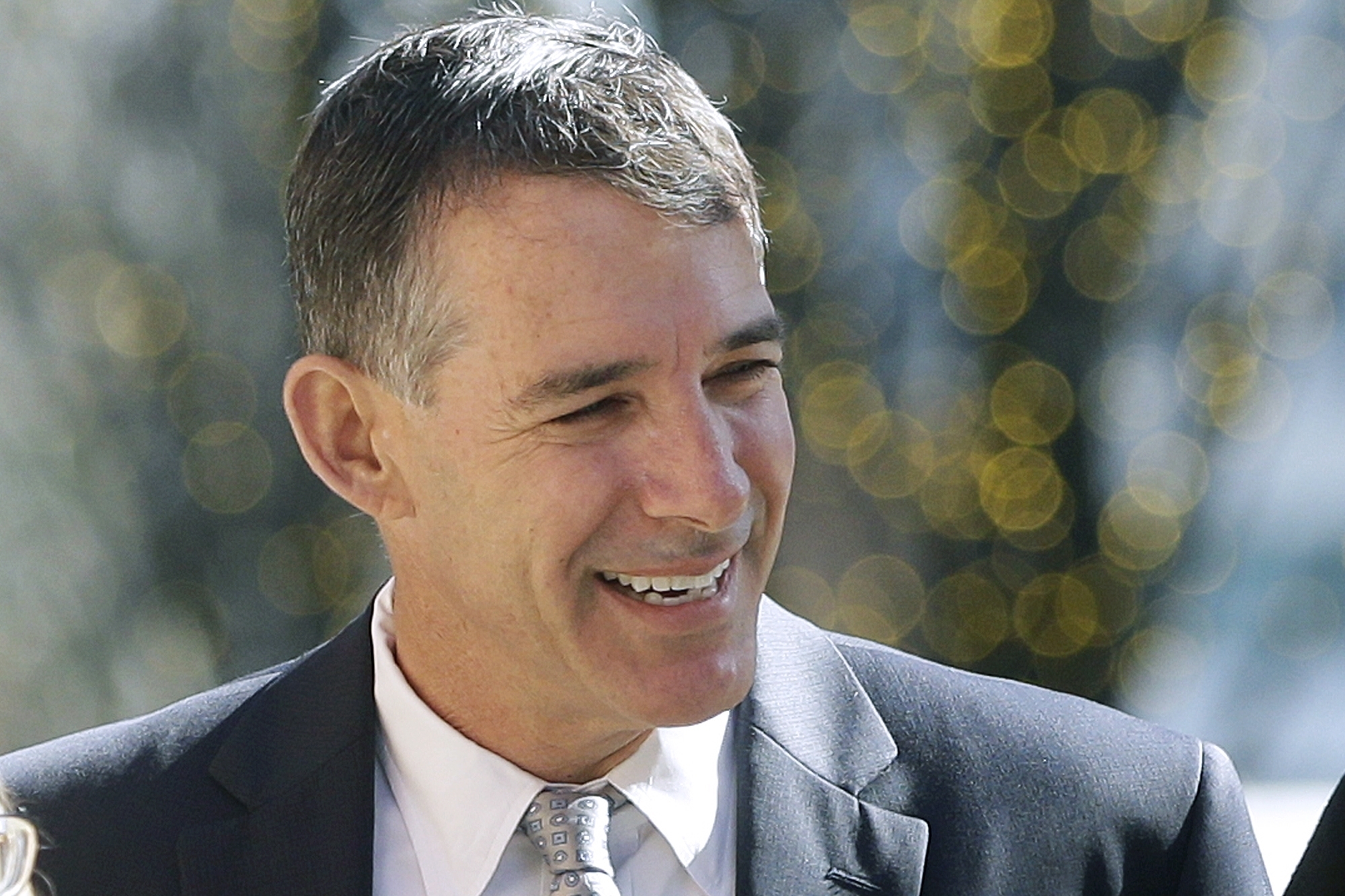 Ex-coach gets 6 months in college scam, runs from courthouse