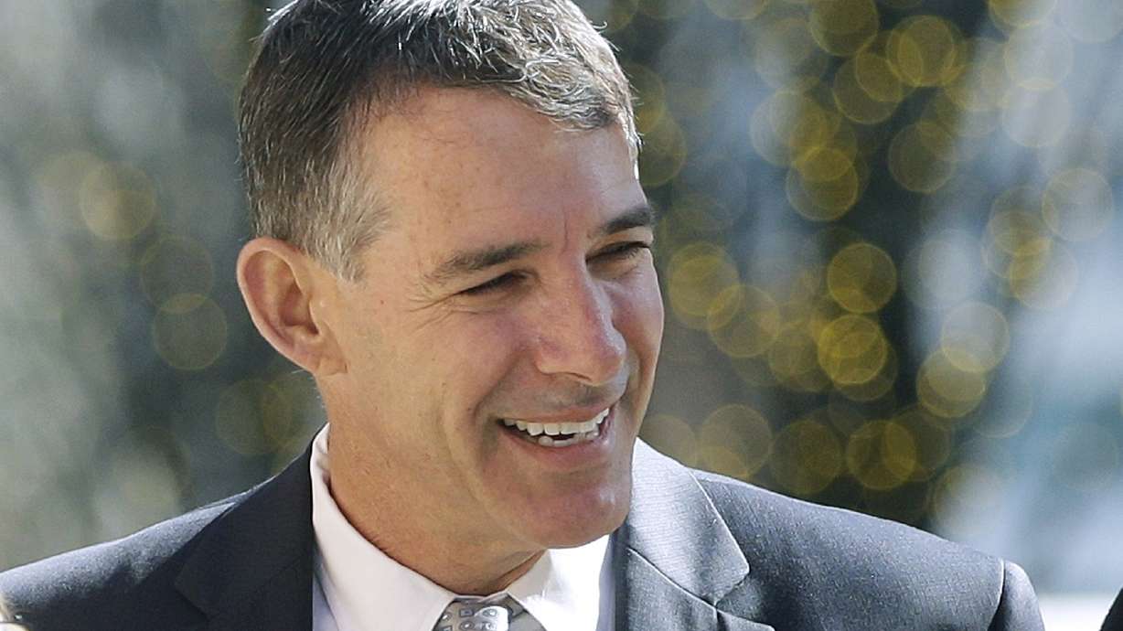 Ex-coach gets 6 months in college scam, runs from courthouse