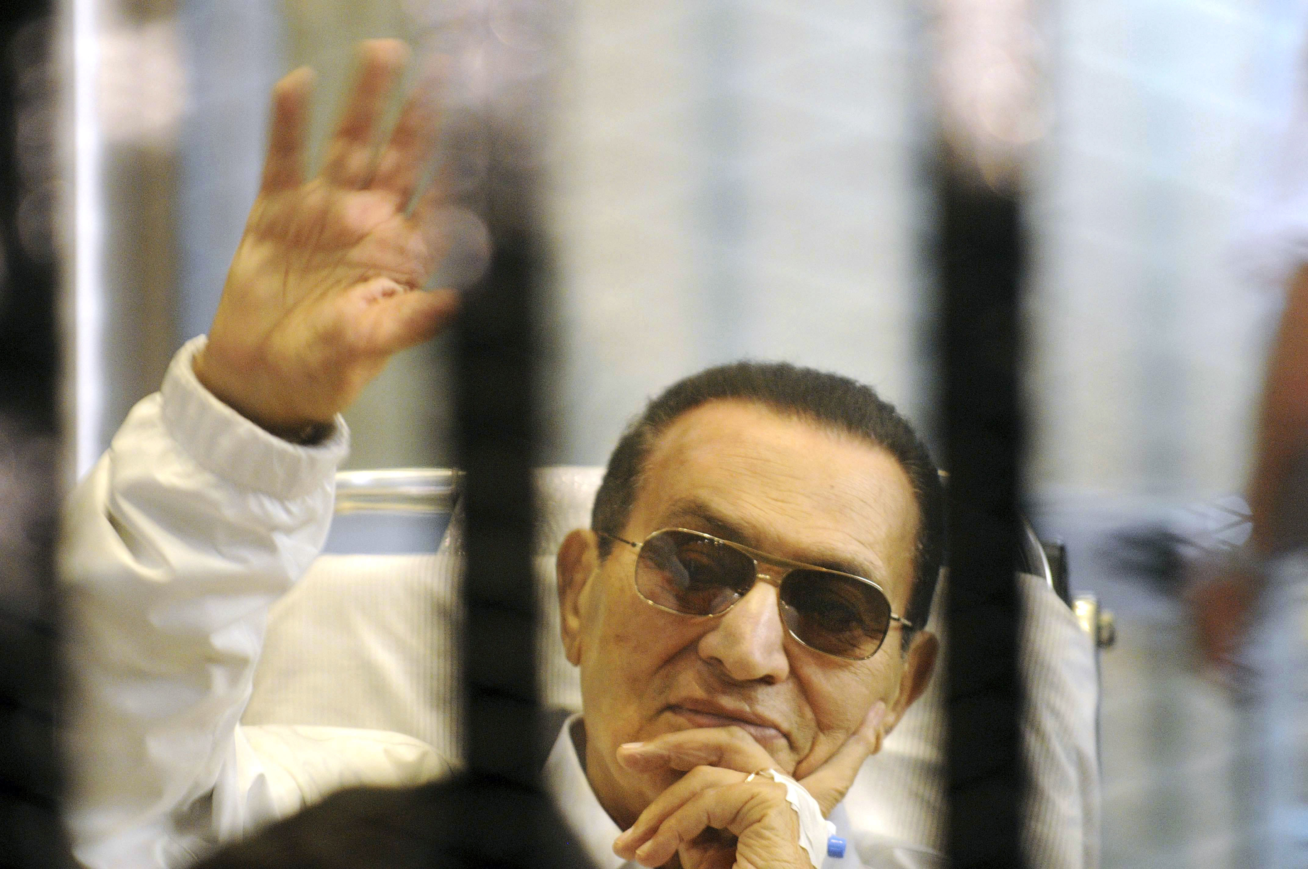 FILE - In this April 13, 2013 file photo, former Egyptian President Hosni Mubarak waves to his supporters from behind bars as he attends a hearing in his retrial on appeal in Cairo, Egypt. Photo: AP Photo, File