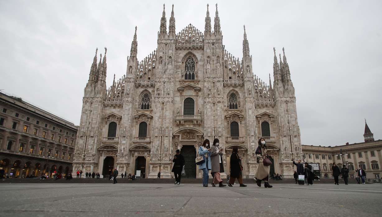 Women wearing face masks walks past the Duomo gothic cathedral in Milan, Italy, Tuesday, Feb. 25, 2020. Civil protection officials on Tuesday reported a large jump of cases in Italy, from 222 to 283. Seven people have died, all of them elderly people suffering other pathologies. (Antonio Calanni, AP Photo)