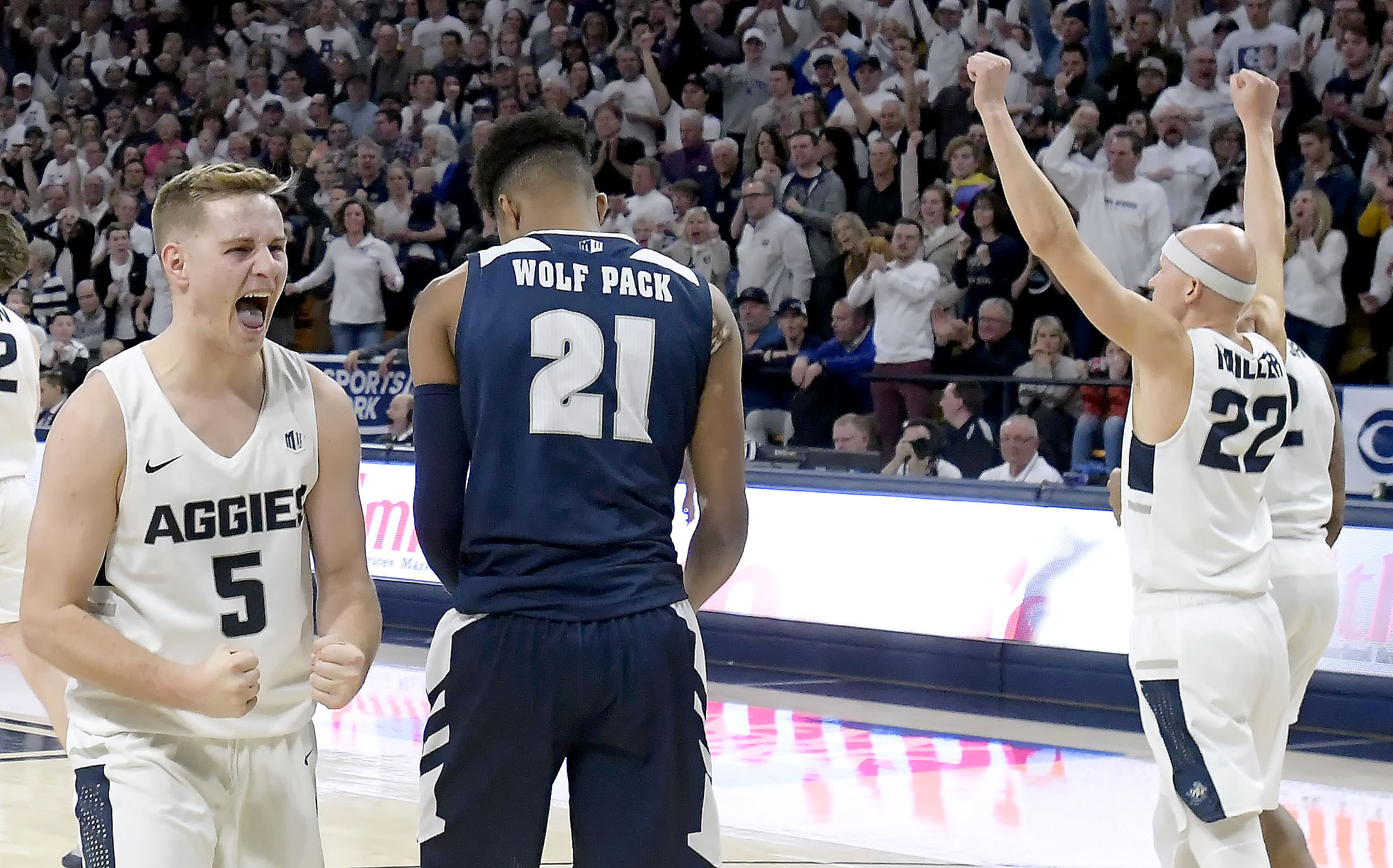 Utah State guard Sam Merrill (5) and guard Brock Miller (22) celebrate next to Nevada forward Jordan Brown (21) after Merrill drew a charge during an NCAA college basketball game Saturday, March 2, 2019, in Logan, Utah. (Photo: Eli Lucero, The Herald Journal via AP)