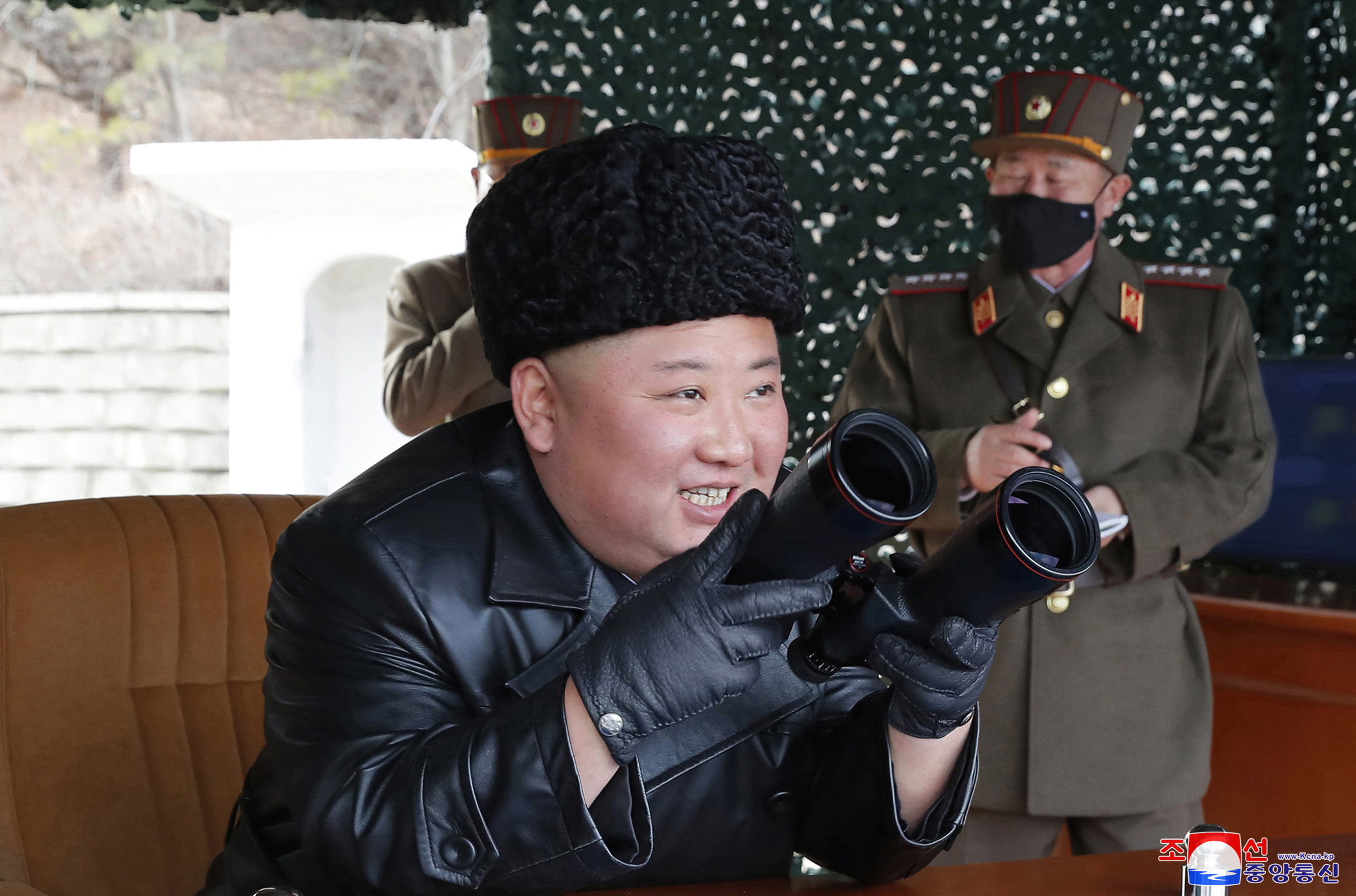 Kim watches N Korea military drill alongside masked officers