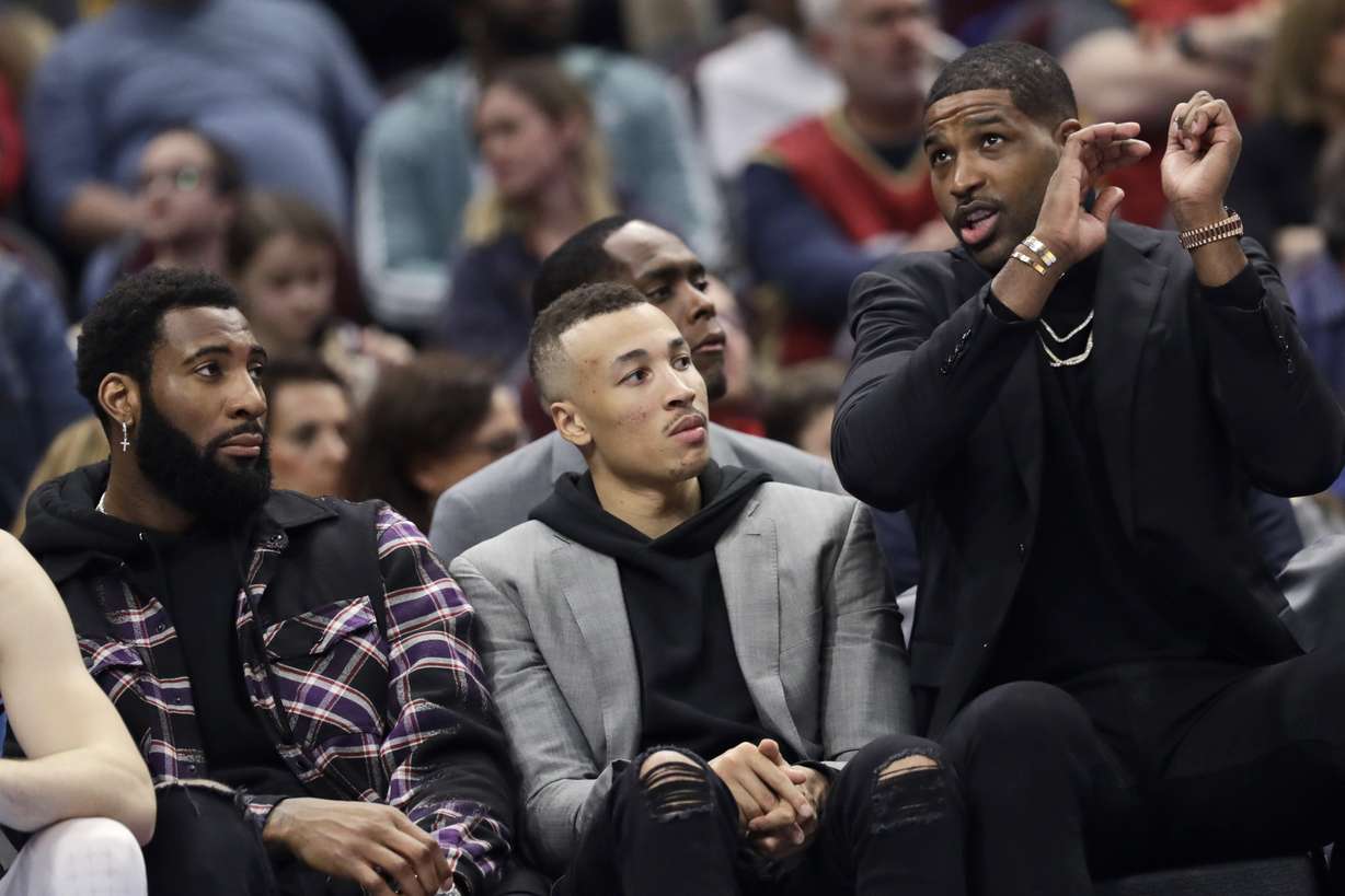 Dante Exum, center, watches from the bench in the second half of an NBA basketball game against the Utah Jazz, Monday, March 2, 2020, in Cleveland. (AP Photo/Tony Dejak)