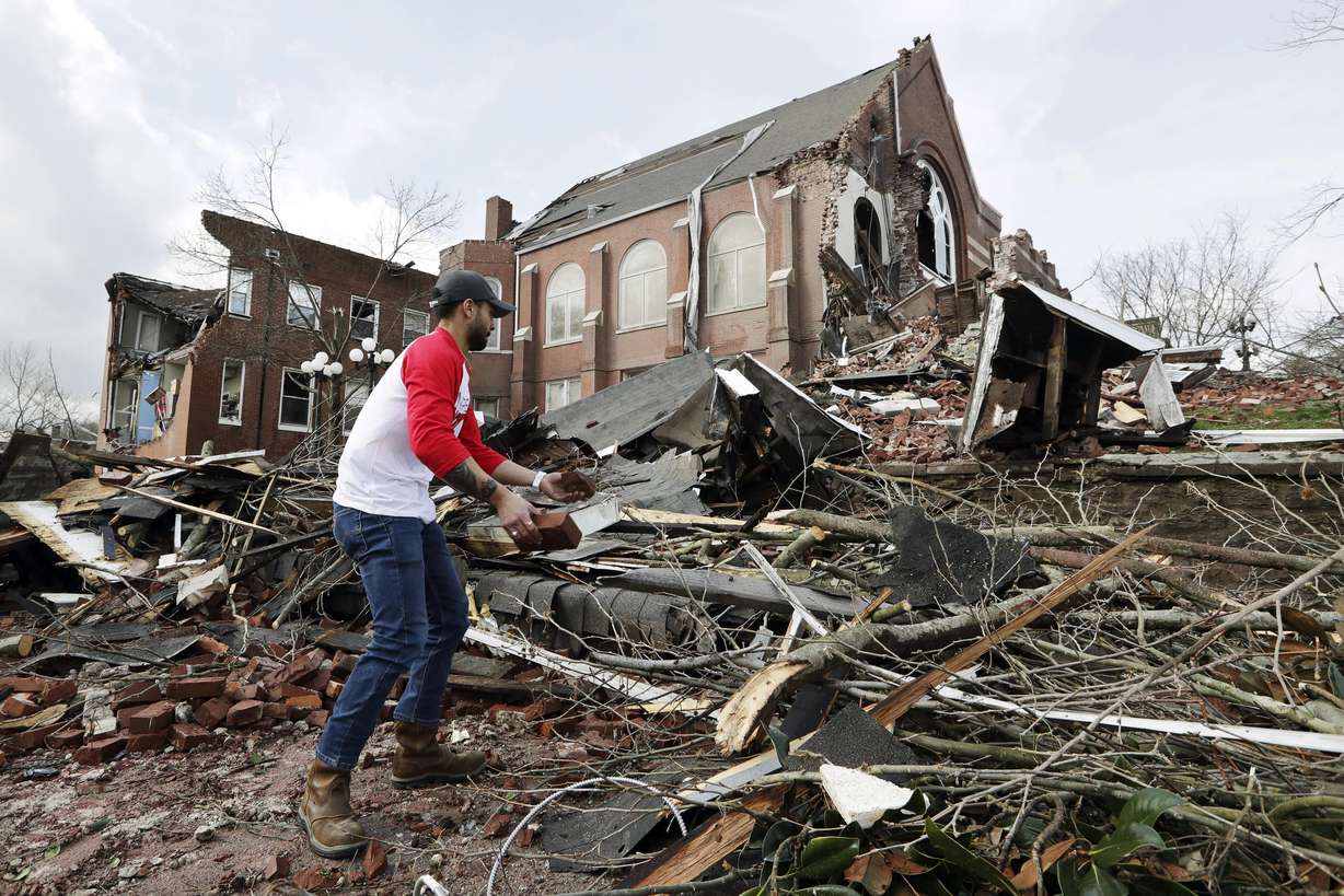 Sumant Joshi helps to clean up rubble at the East End United Methodist Church after it was heavily damaged by storms Tuesday, March 3, 2020, in Nashville, Tenn. Joshi is a resident in the area and volunteered to help clean up. Tornadoes ripped across Tennessee early Tuesday, shredding buildings and killing multiple people. (Mark Humphrey, AP Photo)