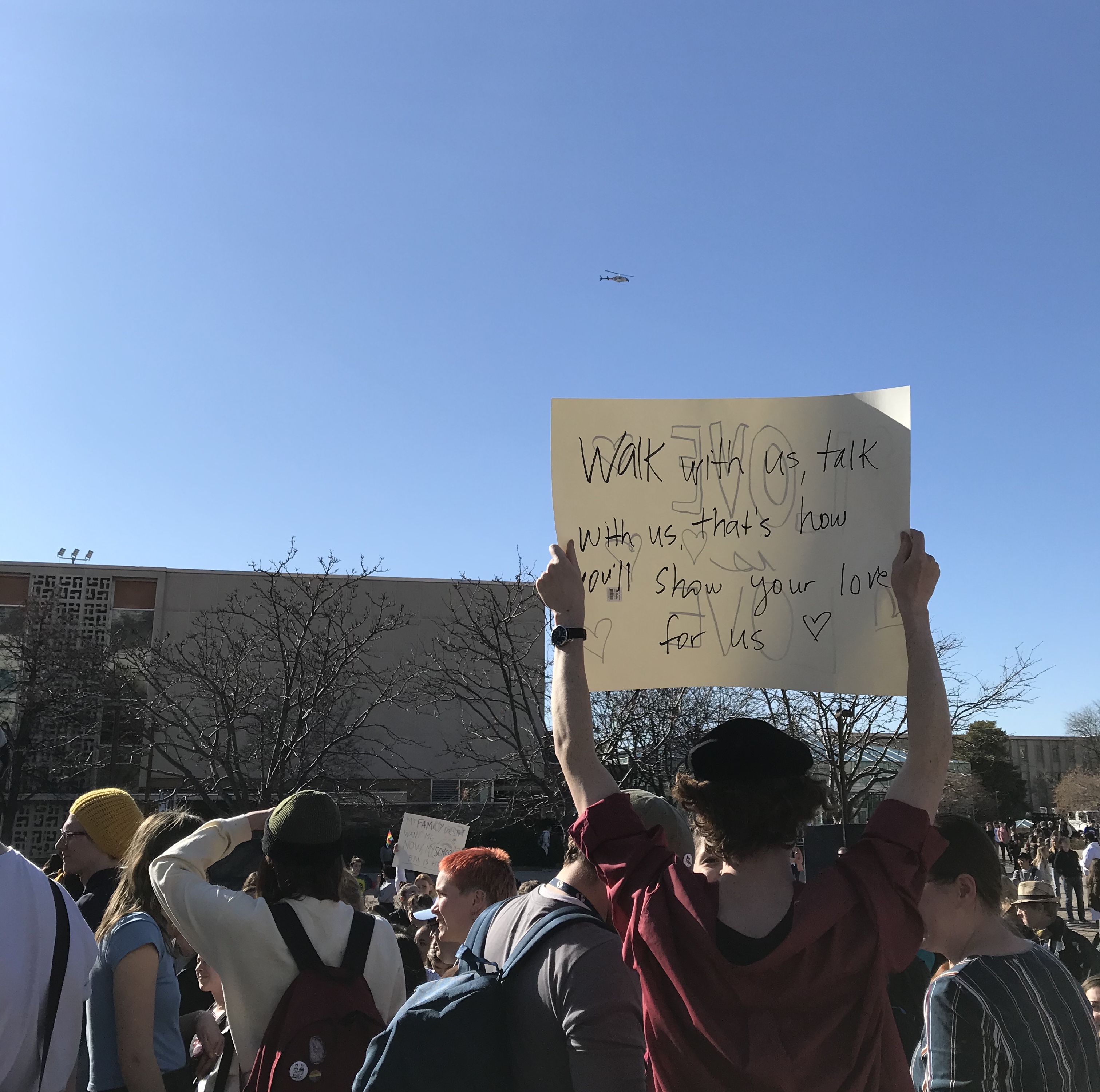 BYU students wave signs at a passing helicopter during a protest of the university's recent clarification of changes to the Honor Code near the Wilkinson Student Center, Wednesday, March 4, 2020 in Provo. (Photo: Sean Walker, KSL.com)