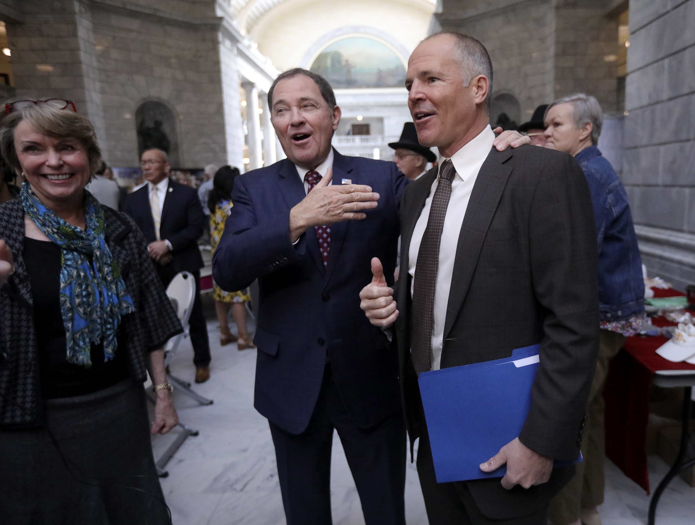 Gov. Gary Herbert, center, talks with Nathan Rafferty, Ski Utah CEO, and Vicki Varela, managing director of the Utah Office of Tourism, during Tourism Day at the Capitol in Salt Lake City on Wednesday, March 4, 2020. (Kristin Murphy, KSL)