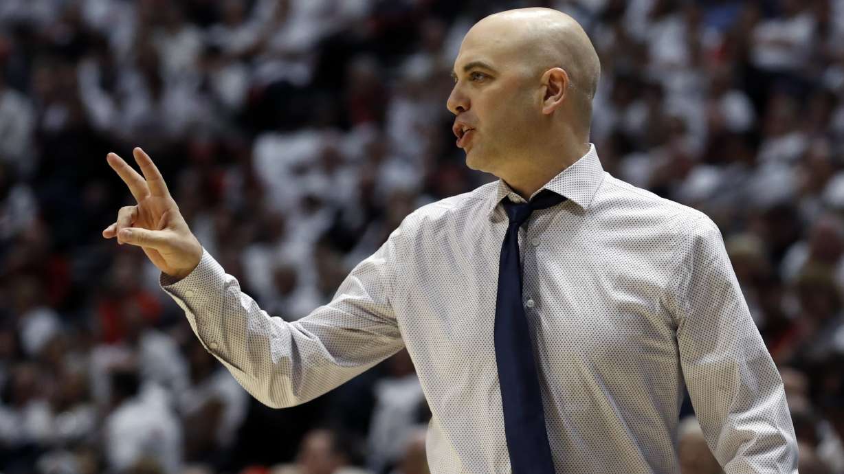 Utah State coach Craig Smith gestures during the first half of the team's NCAA college basketball game against San Diego State, Saturday, Feb. 1, 2020, in San Diego. (AP Photo/Gregory Bull)