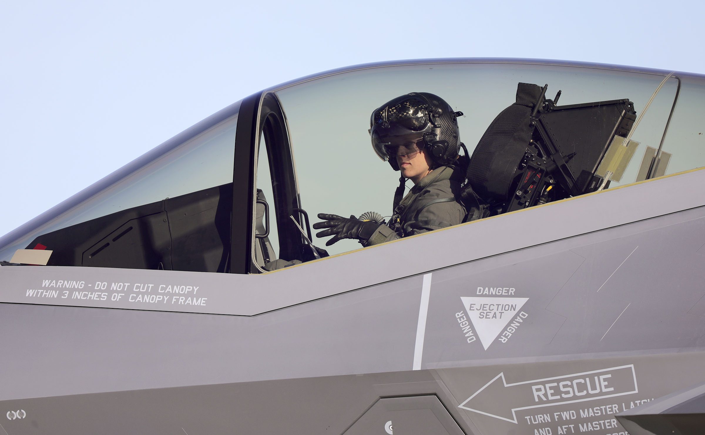 Air Force Capt. Kristin “BEO” Wolfe takes her gloves off at Hill Air Force Base on Thursday, March 5, 2020, after flying an F-35A Lightning II during training for upcoming air shows. (Kristin Murphy, KSL)