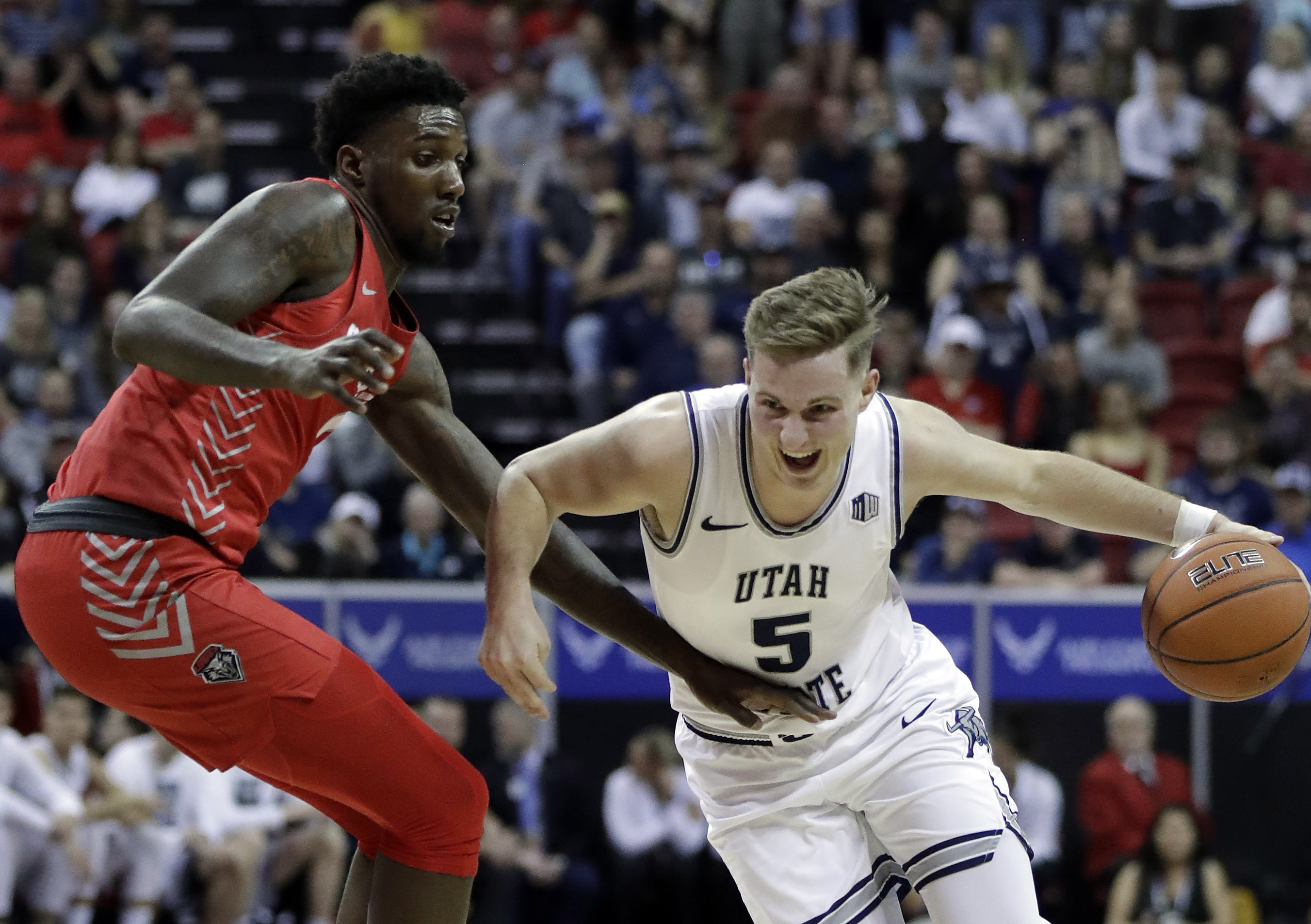 Utah State's Sam Merrill drives as New Mexico's Corey Manigault defends during the first half of a Mountain West Conference tournament NCAA college basketball game Thursday, March 5, 2020, in Las Vegas. (Photo: Isaac Brekken, AP)