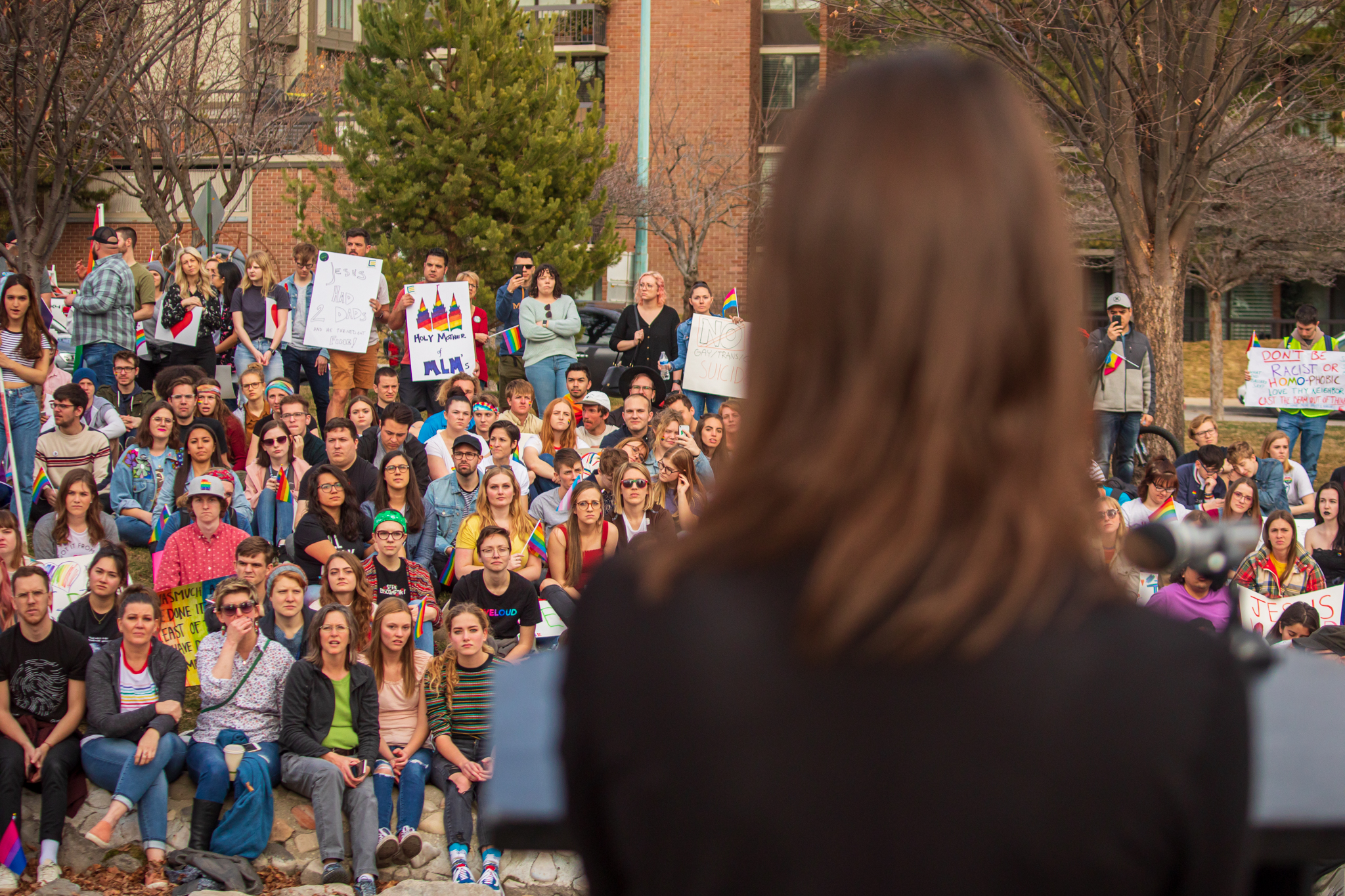 A crowd of protesters listen as AnnElise Guerisoli, of California and a BYU alumna, speaks at City Creek Park in Salt Lake City on Friday, March 6, 2020. Guerisoli helped plan the event, which protested a recent clarification about “same-sex romantic behavior” in the BYU’s Honor Code. (Photo: Carter Williams, KSL.com)