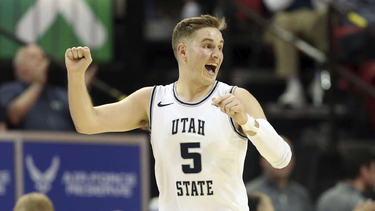 Utah State's Sam Merrill plays against Wyoming during the second half of an NCAA college basketball game in the Mountain West Conference men's tournament Friday, March 6, 2020, in Las Vegas. (AP Photo/Isaac Brekken)