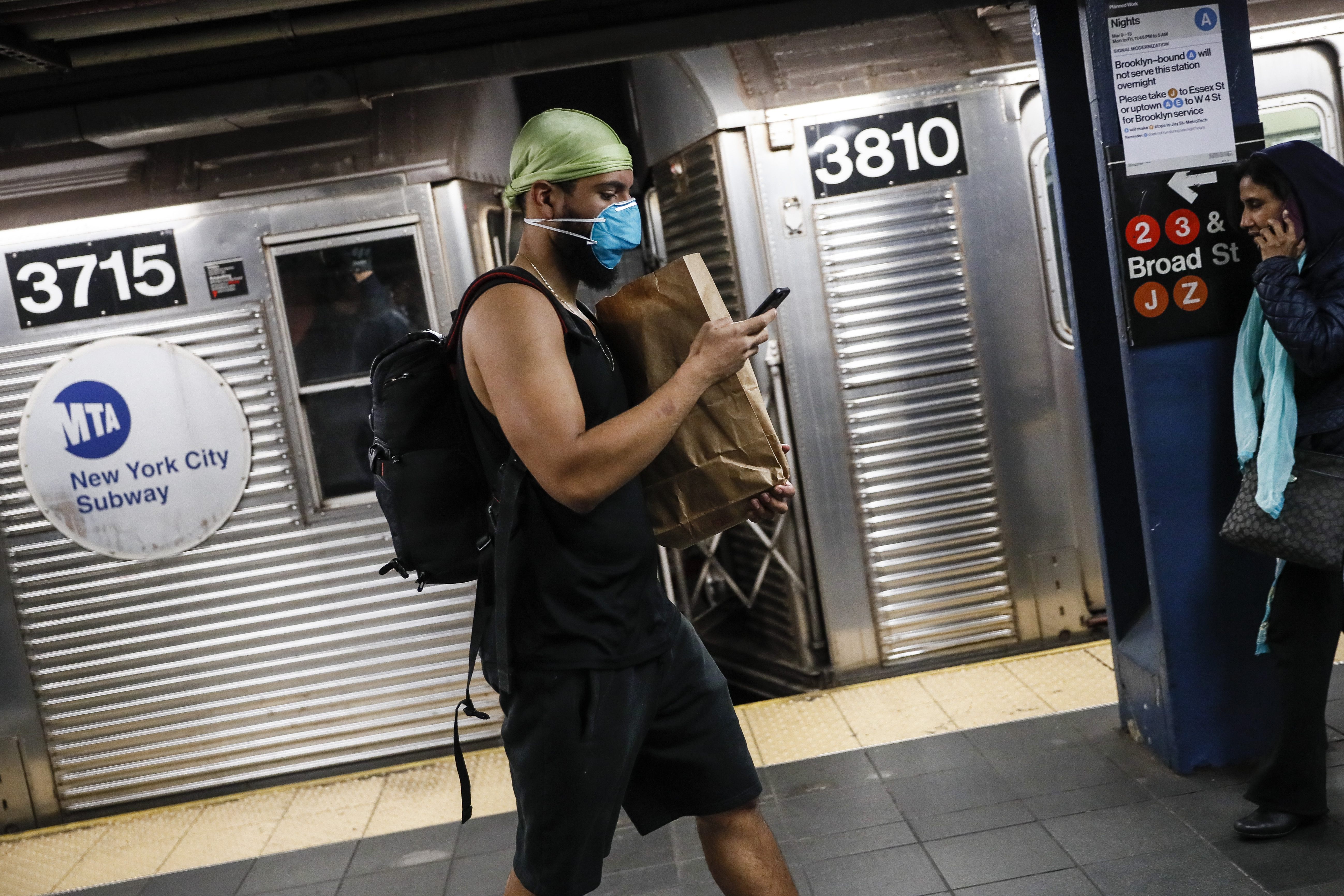 Wary New York subway riders carry on amid virus concerns