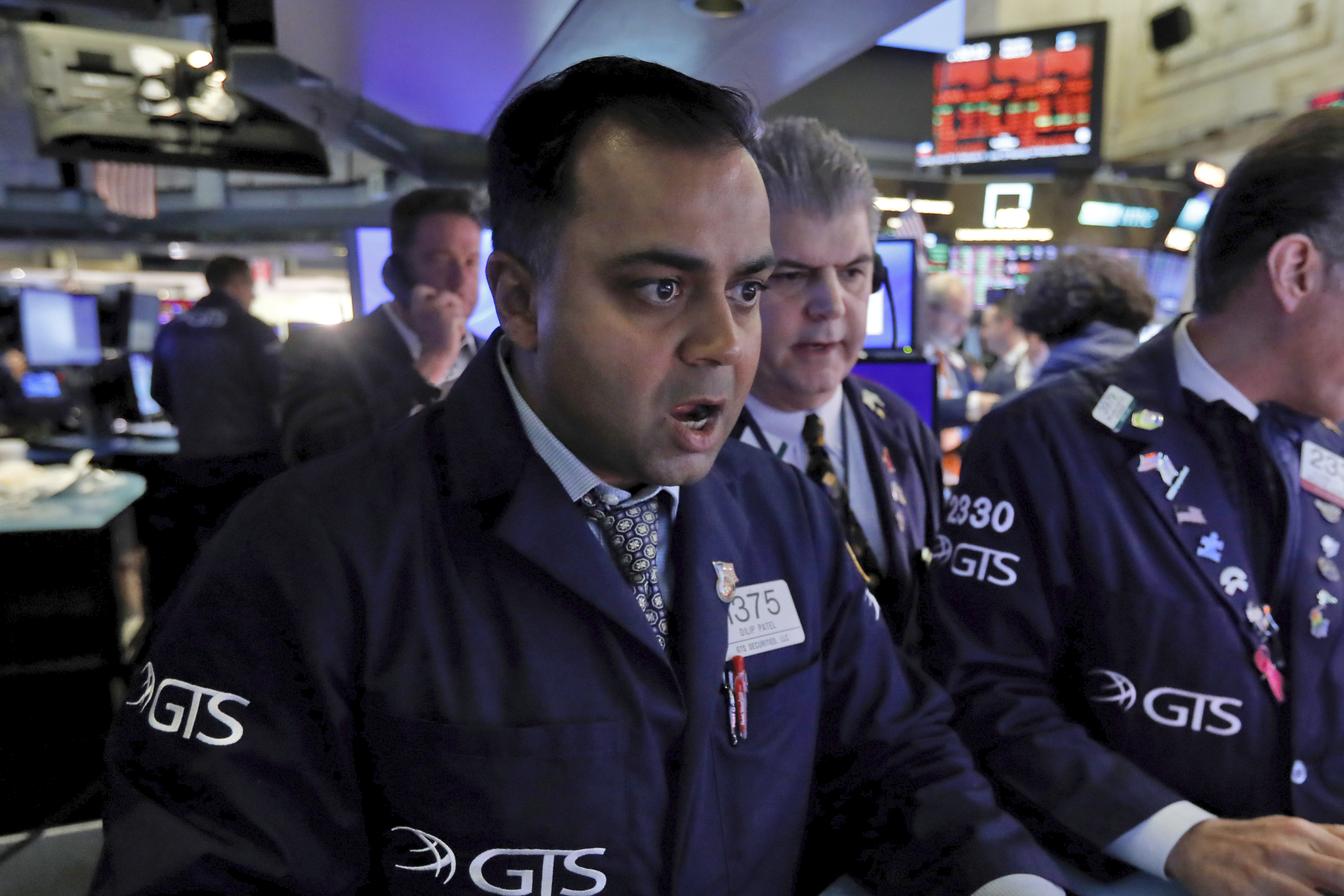 Specialist Dilip Patel, left, works at his post on the floor of the New York Stock Exchange, Monday, March 9, 2020. The Dow Jones Industrial Average sank 7.8%, its steepest drop since the financial crisis of 2008, as a free-fall in oil prices and worsening fears of fallout from the spreading coronavirus outbreak seize markets. (Richard Drew, AP Photo)