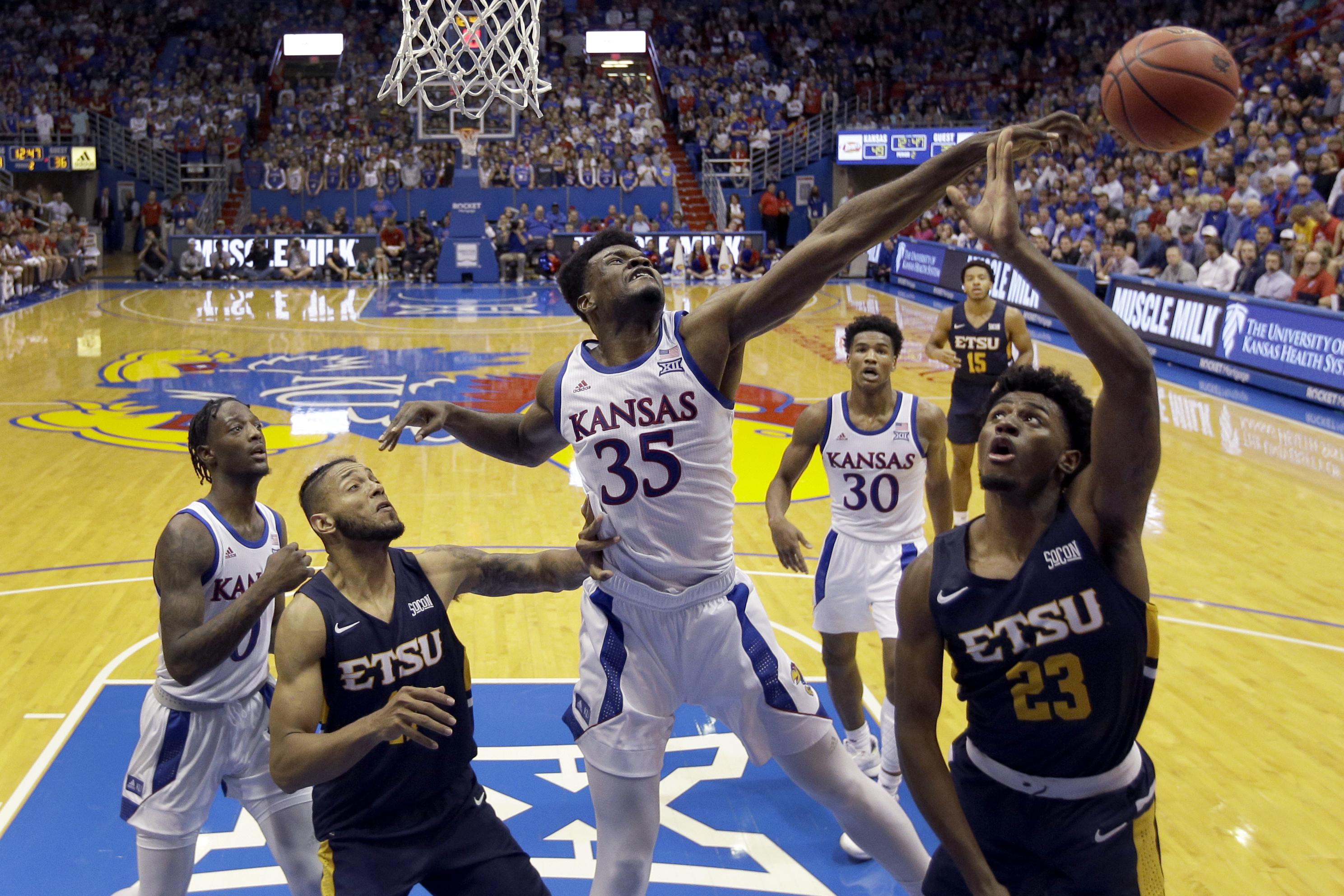 In this Nov. 19, 2019, file photo, Kansas center Udoka Azubuike (35) blocks a shot by East Tennessee State forward Vonnie Patterson (23) during the second half of an NCAA college basketball game in Lawrence, Kan. Azubuike was selected to the Associated Press All-Big 12 first team announced Tuesday, March 10, 2020. Azubuike was also named the AP Big 12 Player of the Year. (AP Photo: Charlie Riedel, File)