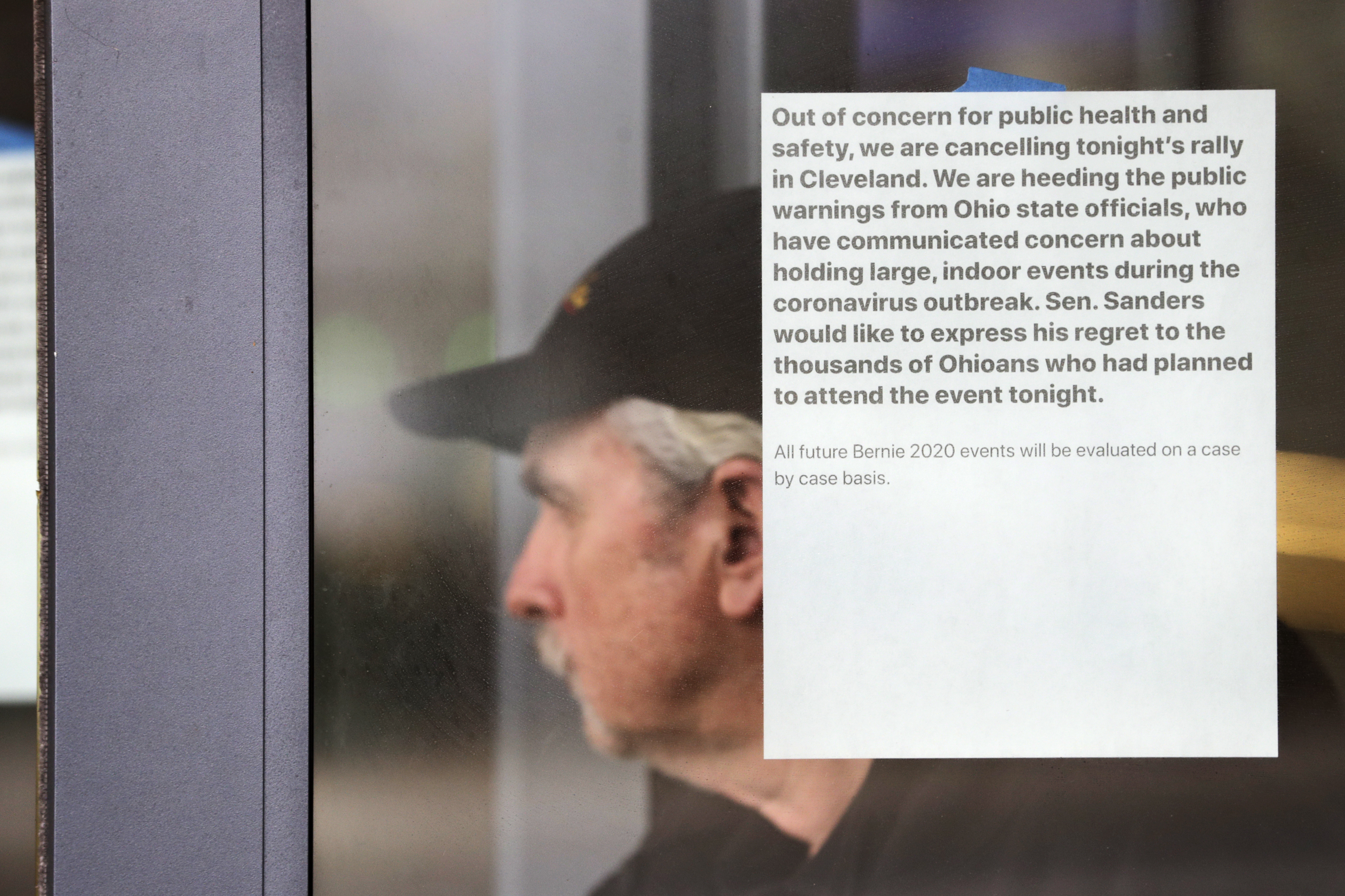 A man walks out of the Huntington Convention Center of Cleveland where Democratic presidential candidate Sen. Bernie Sanders, I-Vt., was prepared to hold a campaign rally, Tuesday, March 10, 2020, in Cleveland. The Cleveland rally was canceled due to concerns about coronavirus. (Tony Dejak, AP Photo)