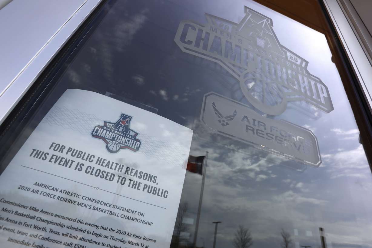 A sign posted at an entrance to Dickies Arena where the NCAA college basketball games in the American Athletic Conference tournament were to be played Thursday, March 12, 2020 in Fort Worth, Texas. The tournament was canceled due to coronavirus concerns. (AP Photo)