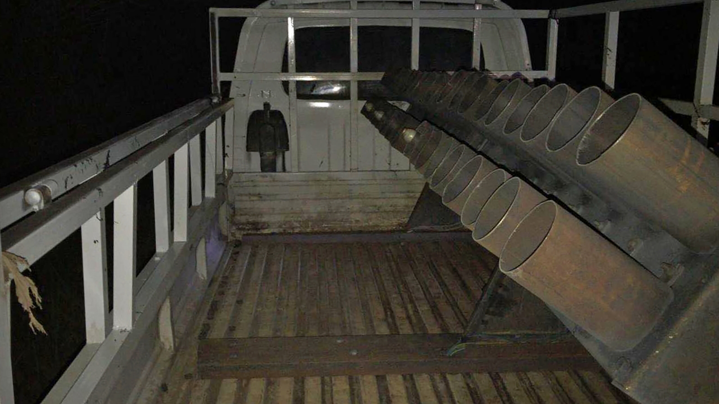 This photo released by the government-affiliated Media Security Cell on Thursday, March 12, 2020, shows a rocket-rigged truck launcher after a rocket attack on Camp Taji, a few miles north of Baghdad, in Rashidiya, Iraq. Iraq's military on Thursday said it opened an investigation into the rocket attack that hours earlier killed three servicemen, including two Americans, at an Iraqi base housing coalition forces that has been used as a training base for a number of years. (Media Security Cell via AP)