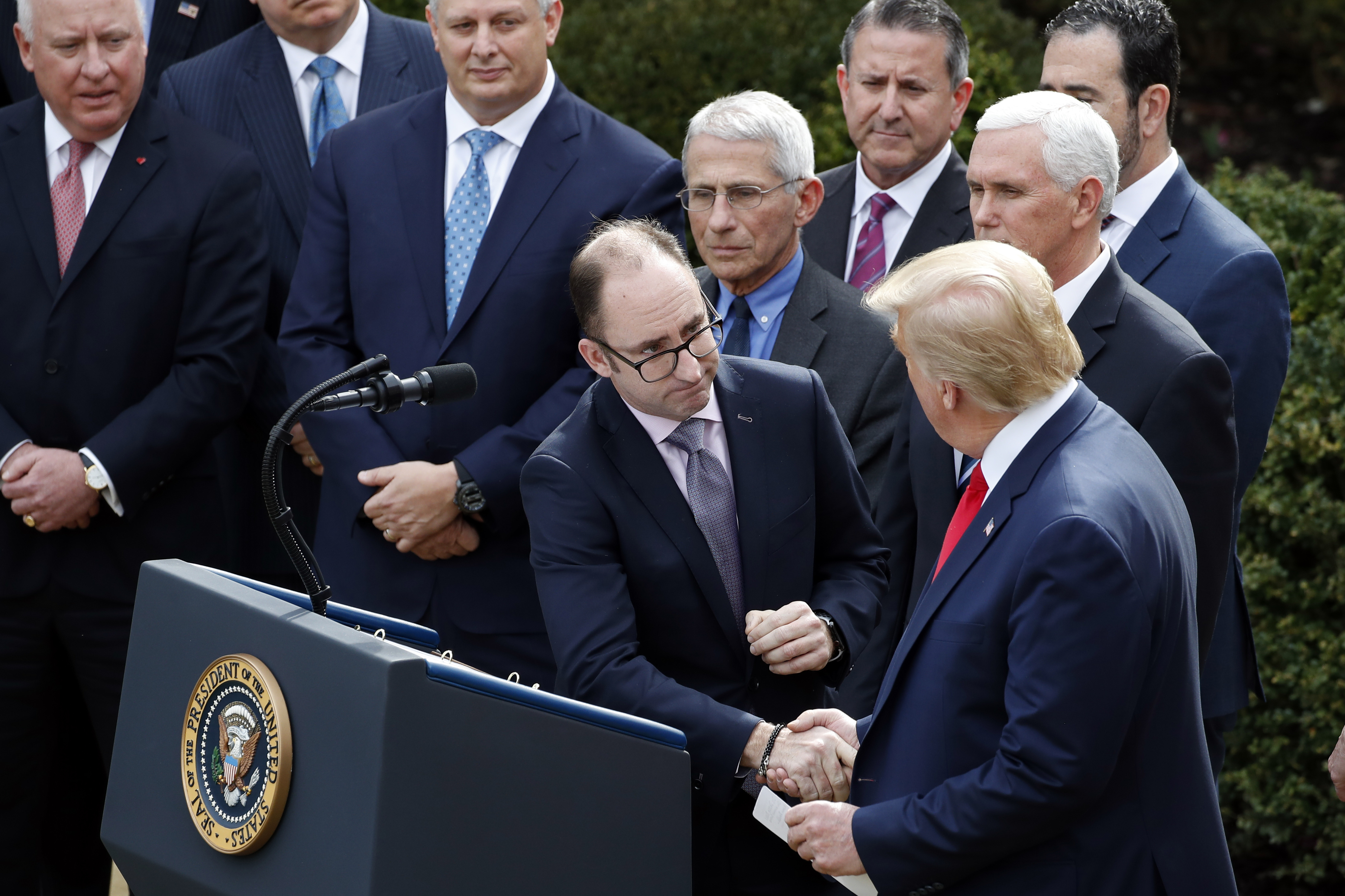 Despite coronavirus, Trump keeps shaking hands