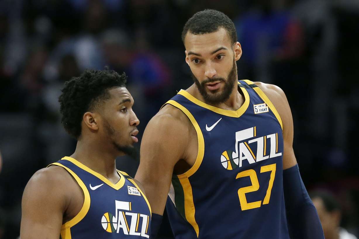 In this Saturday, March 7, 2020, file photo, Utah Jazz center Rudy Gobert (27) talks with guard Donovan Mitchell, left, during the second half of an NBA basketball game against the Detroit Pistons, in Detroit. Both players have tested positive for COVID-19. (Photo: Duane Burleson, AP)