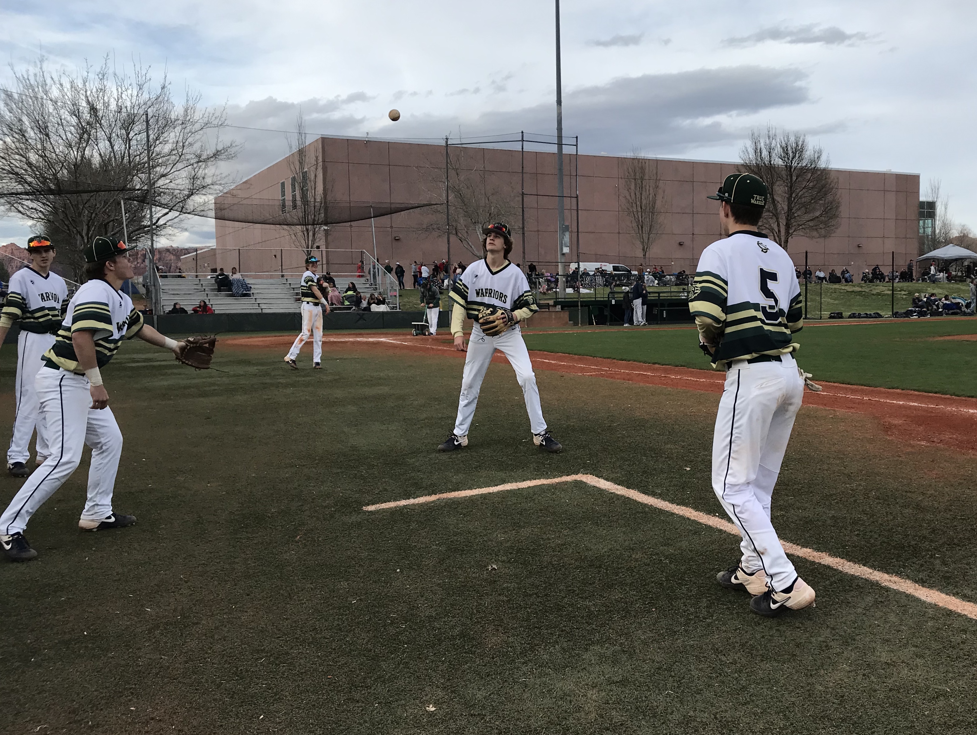 Snow Canyon baseball players warm up before a game in Santa Clara, Saturday, March 14, 2020 at Snow Canyon High School. All UHSAA-sanctioned events have been suspended for two weeks during a statewide moratorium while public school in-person classes are also on hiatus. (Photo: Sean Walker, KSL.com)