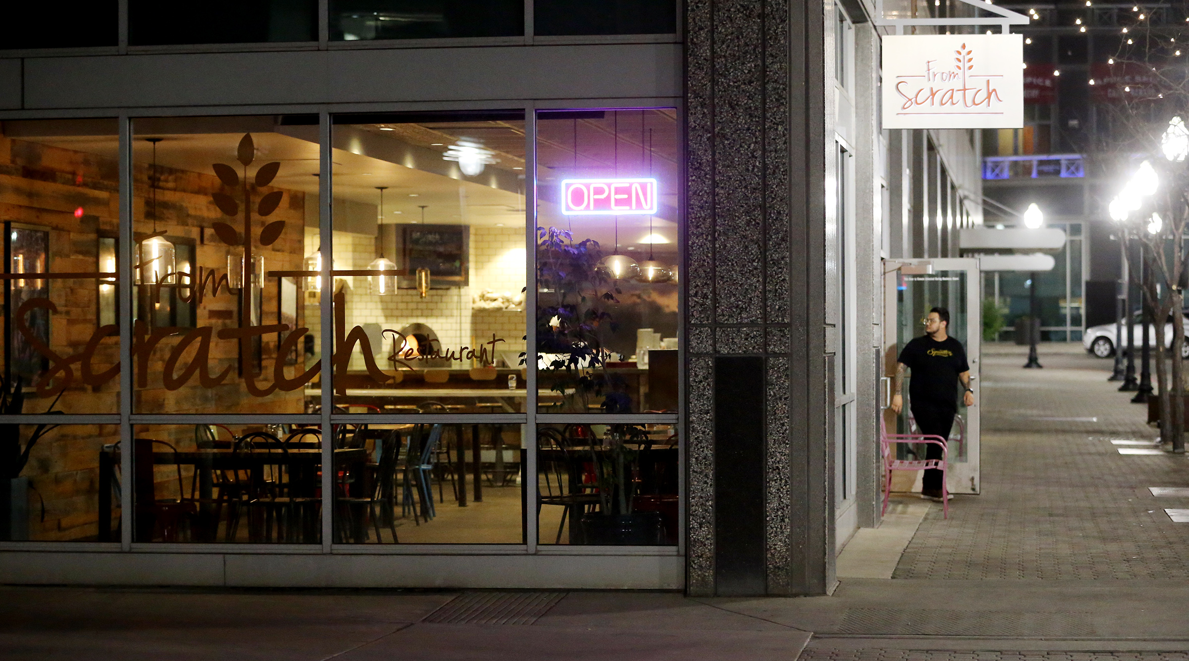 Josue Mejicanos, who is a server for two different restaurants in Salt Lake City, walks out onto the sidewalk near the Gallivan Center on Saturday, March 14, 2020. He says that there has been a noticeable difference in the number of people downtown on a Saturday evening. Coronavirus concerns are keeping many people home. (Photo: Scott G Winterton, KSL)