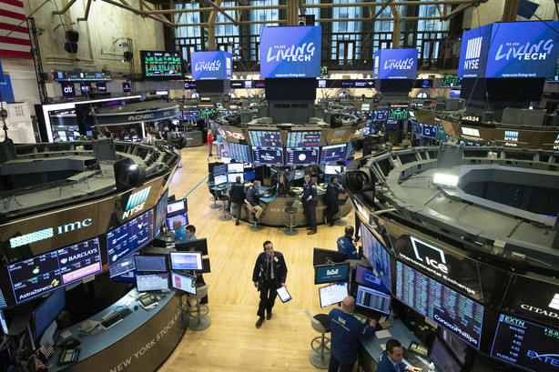 FILE - In this Friday, March 13, 2020, file photo, a trader walks on the floor of the New York Stock Exchange during President Donald Trump's televised speech from the White House, in New York. (AP Photo/Mark Lennihan, File)