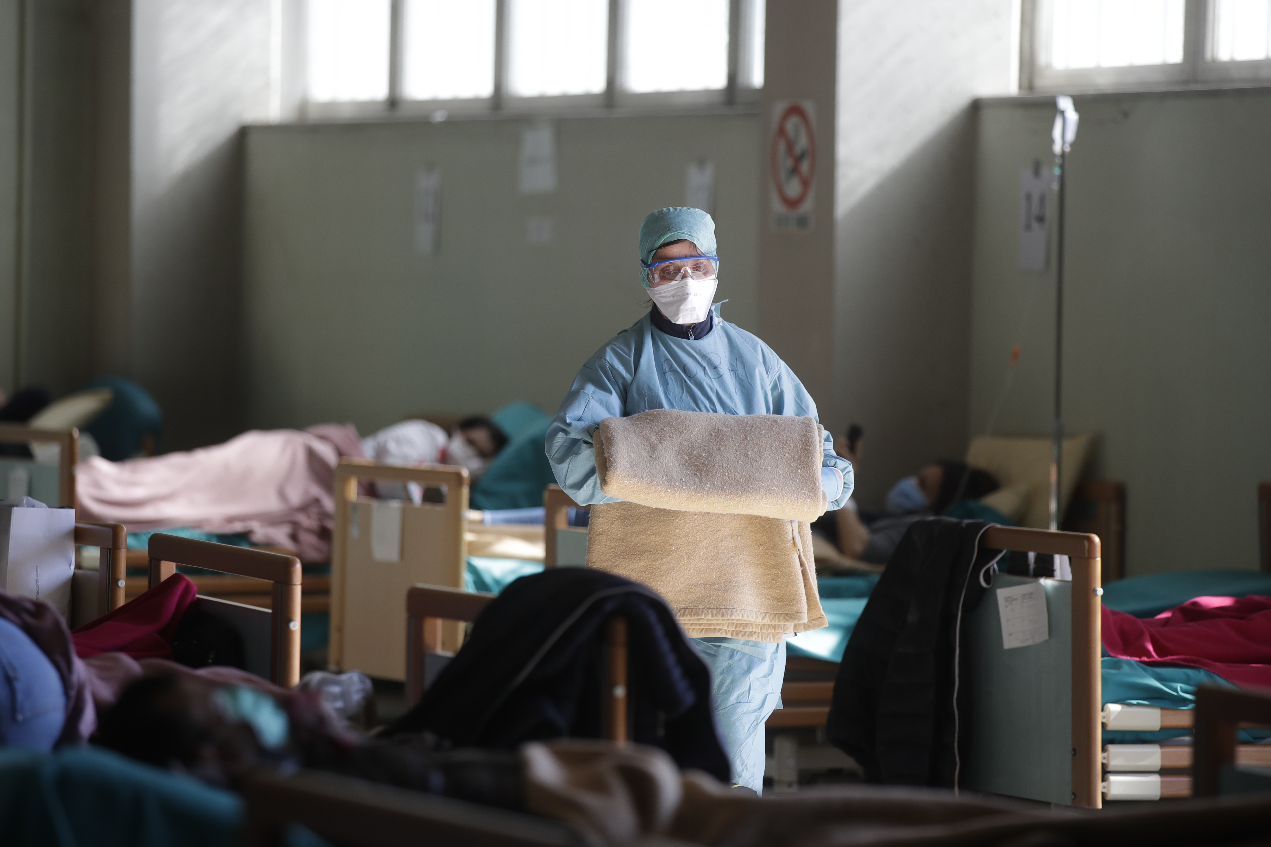 Medical staff work at one of the emergency structures that were set up to ease procedures at the Brescia hospital, northern Italy, Monday, March 16, 2020. For most people, the new coronavirus causes only mild or moderate symptoms. For some, it can cause more severe illness, especially in older adults and people with existing health problems. (Luca Bruno, AP Photo)