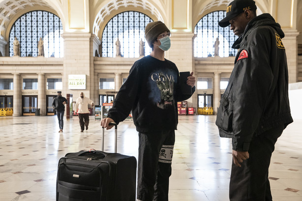 A traveler talks with a security officer at Washington Union Station, a major transportation hub in the nation's capital, Monday, March 16, 2020. (Photo: J. Scott Applewhite, AP Photo)
