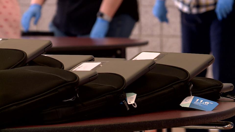Students pick up a computer and accessories at Sunset Ridge Middle School Monday, March 16, 2020 before classes begin online later this week. (Photo: KSL TV)