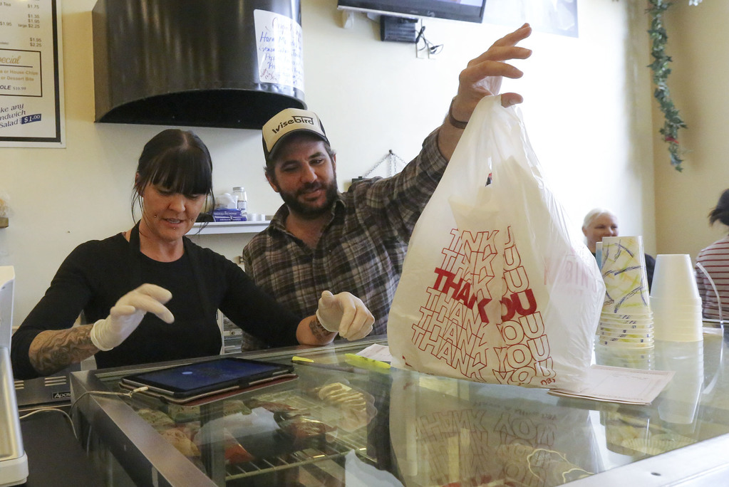 Jessica Keil and Josh Romar prepare a to-go order for a customer at The Robin's Nest in Salt Lake City on Tuesday, March 17, 2020. A Salt Lake County health order prohibits dine-in options for all restaurants, taverns, bars, clubs and entertainment venues in an effort to slow the spread of COVID-19. (Photo: Kristin Murphy, KSL)