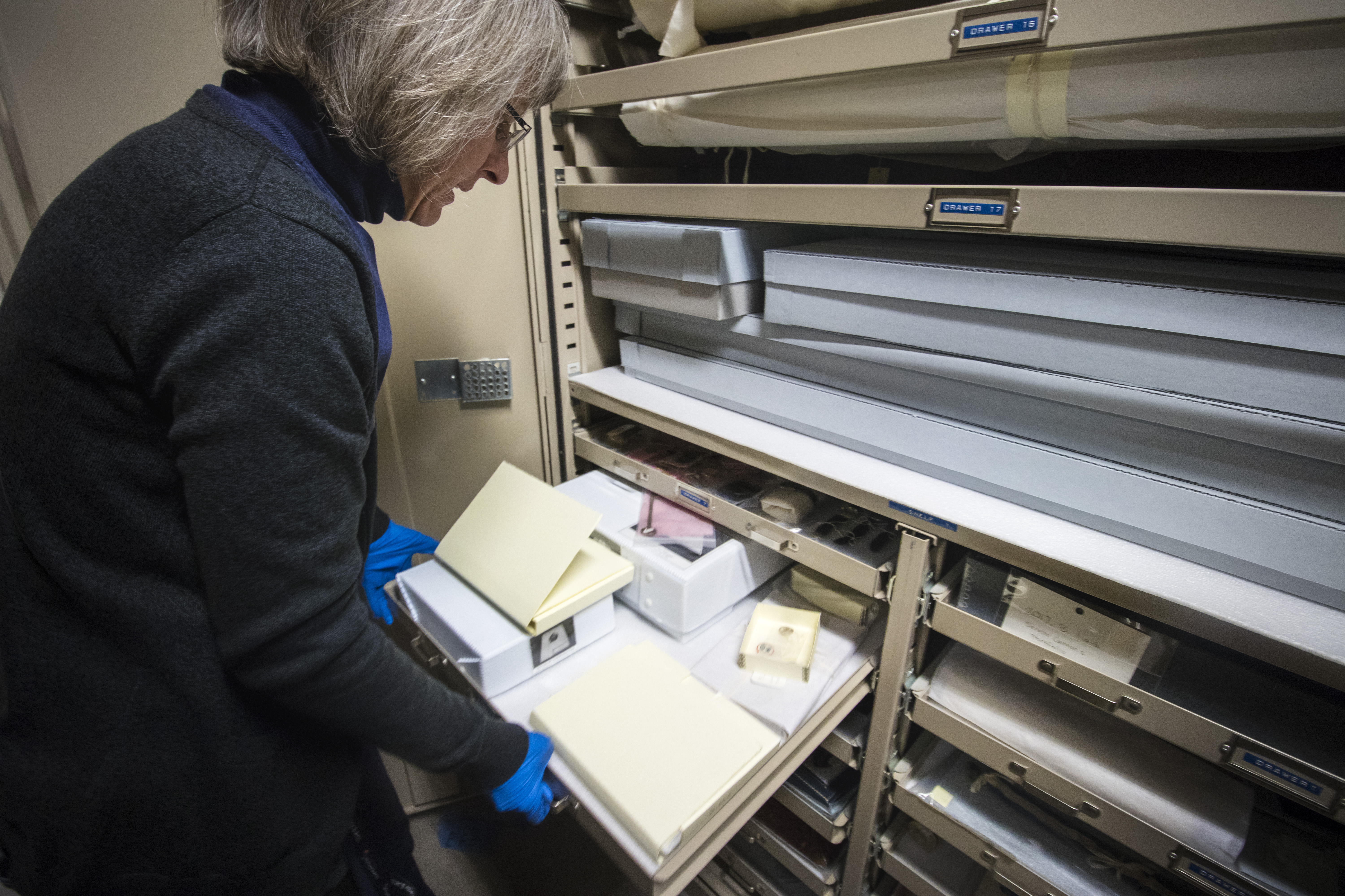 Michele Elnicky, collection specialist for Utah Division of State History, goes through a cabinet drawer that holds an autographed Langston Hughes book and a clock owned by an employee killed in the 1900 Scofield Mine tragedy inside the Utah State Historical Archives in February 2018. (Photo: Carter Williams, KSL.com, File)