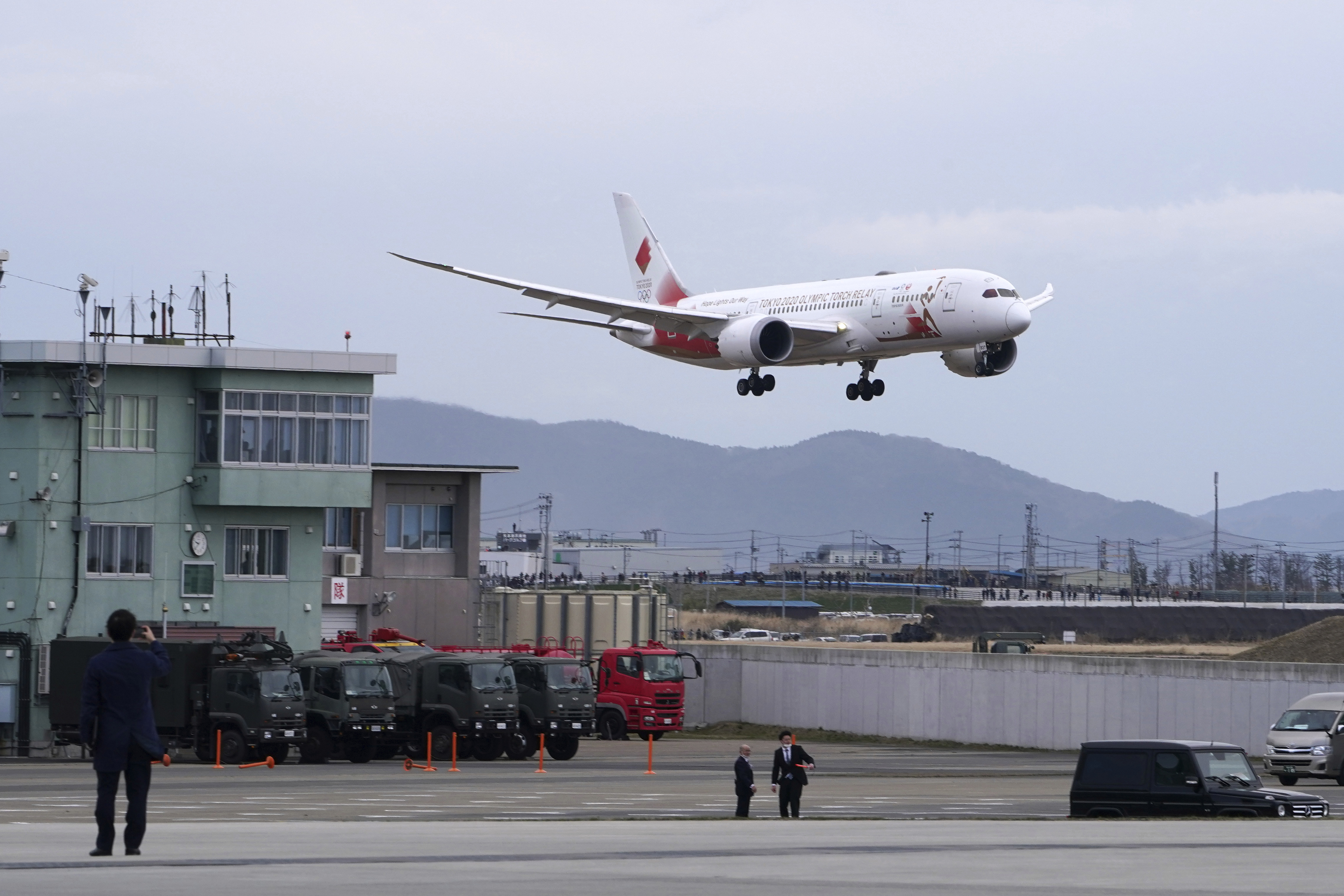 Olympic flame lands in Japan as doubts grow over Tokyo Games