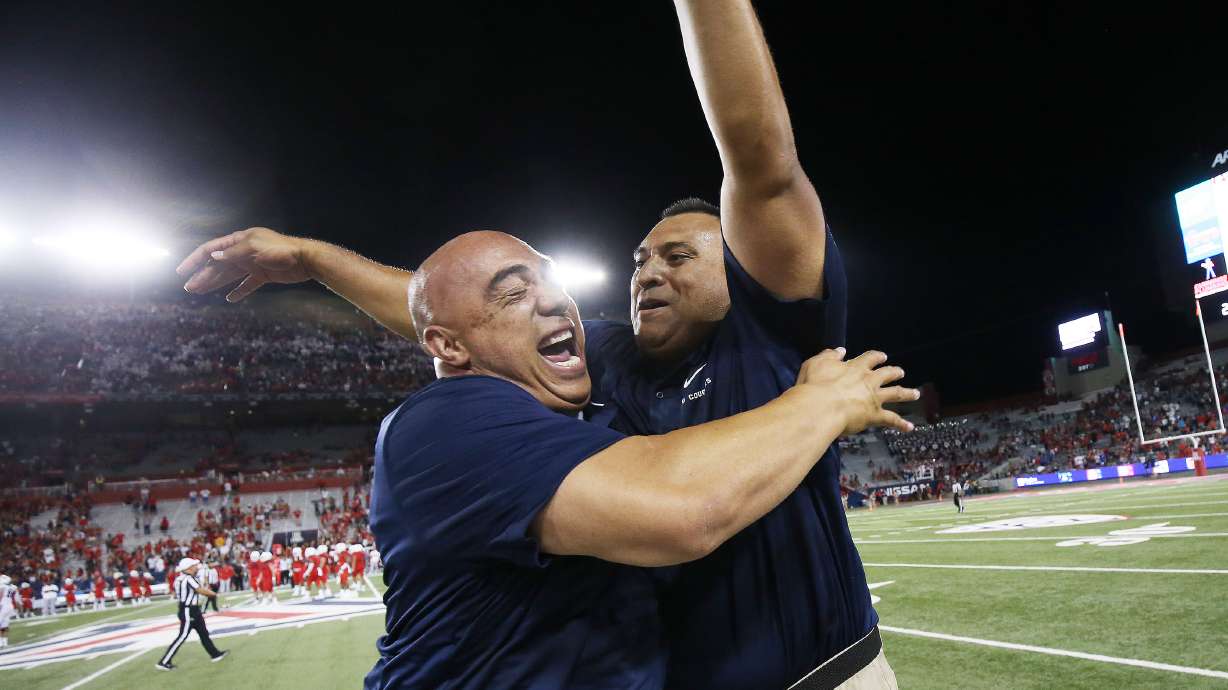 Brigham Young Cougars head coach Kalani Sitake celebrates a win with recruiting director Jasen Ah You in Tucson, Arizona, Sept. 2, 2018. Ah You was recently promoted to assistant athletic director for football academics.