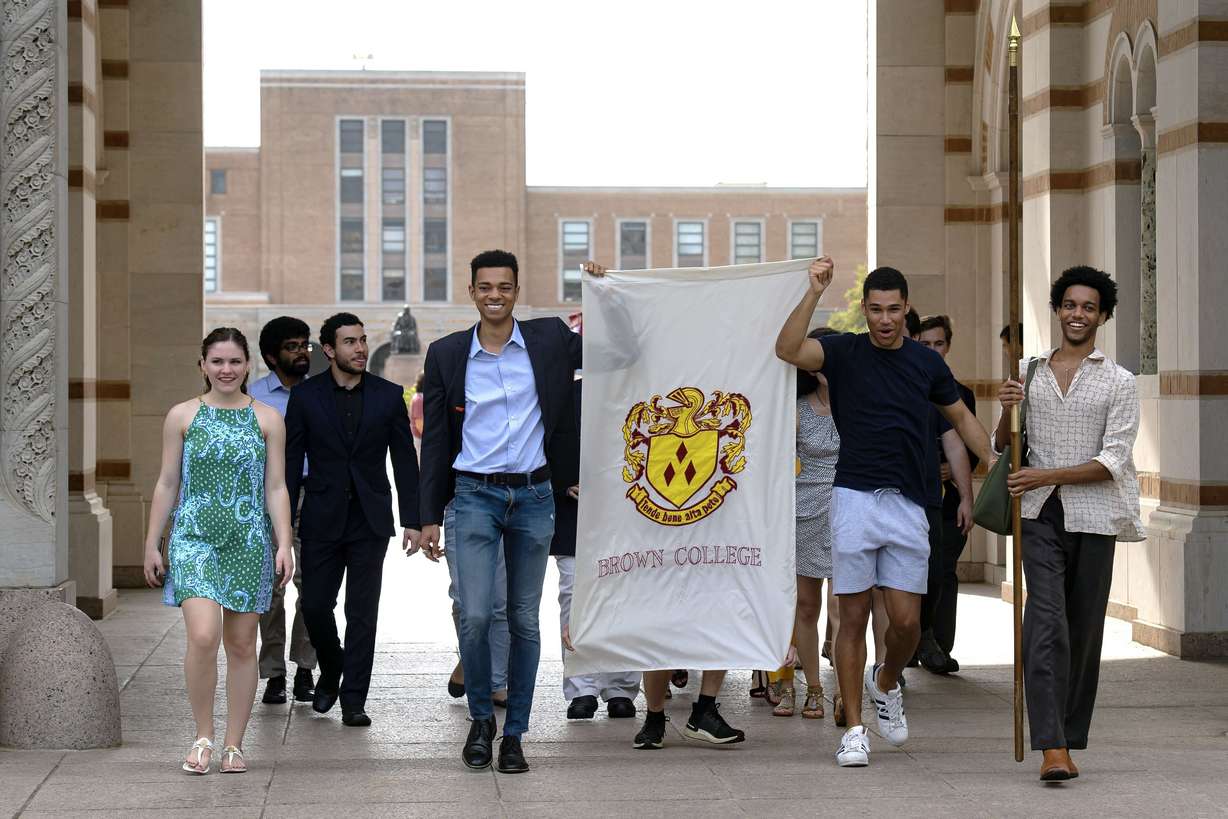 In this March 13, 2020 photo, seniors at Rice University parade through the school's main archway, known as the Sallyport, to continue a commencement tradition at the school in Houston. Due to the coronavirus outbreak it's not clear whether the campus will reopen in time for graduation. The new coronavirus causes mild or moderate symptoms for most people, but for some, especially older adults and people with existing health problems, it can cause more severe illness or death. (Jeff Fitlow/Rice University via AP)