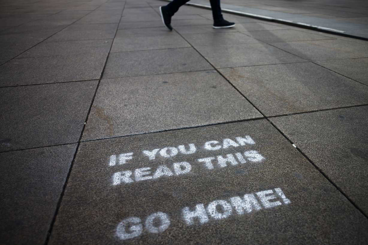 A a message demanding the people to go home is sprayed on the ground of Alexanderplatz square in Berlin, Germany, Monday, March 30, 2020. (AP Photo/Markus Schreiber)