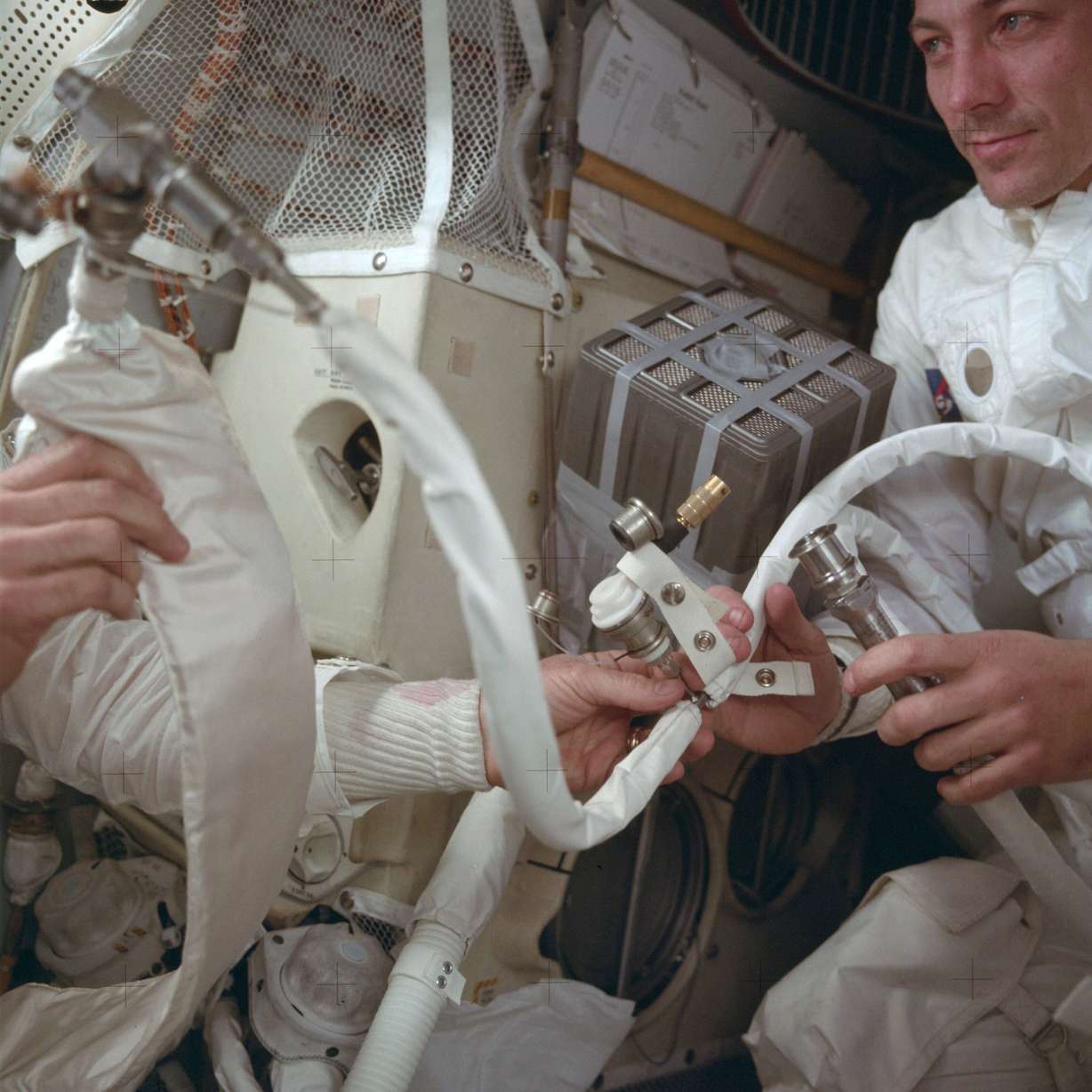 In this April 1970 photo provided by NASA, Apollo 13 command module pilot John Swigert helps to hook up a lithium hydroxide canister in the lunar module, in an effort to get rid of carbon dioxide in the cabin as the spacecraft attempts to return to Earth. (Photo: NASA via AP)