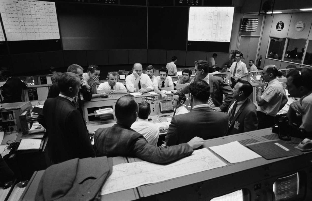 n this April 16, 1970 photo made available by NASA, flight controllers gather in Mission Control in Houston during the last 24 hours of Apollo 13 mission. (NASA via AP)
