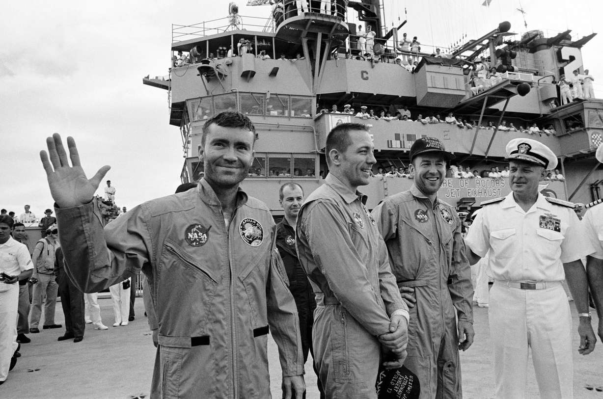 The USS Iwo Jima was the prime recovery ship for the Apollo 13 mission. The crewmembers (from the left) astronauts Fred W. Haise Jr. (waving), lunar module pilot; John L. Swigert Jr., command module pilot; and James A. Lovell Jr., commander; were transported by helicopter to the ship following a smooth splashdown. (Photo: NASA)