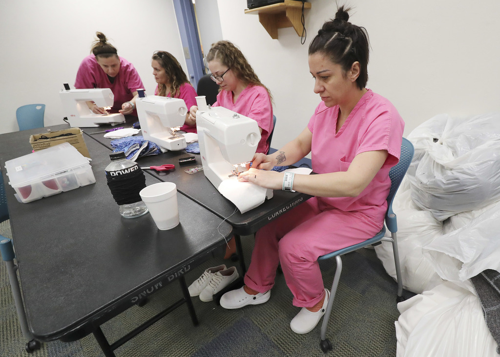 Inmate Laurae Urland, right, sews a protective face mask at the Utah County Security Center in Spanish Fork on Wednesday, April 15, 2020. The women are trying to help curb the spread of coronavirus from jail. The masks are being made for county patrol deputies, suspects, county employees and inmate kitchen workers. (Photo: Jeffrey D. Allred, KSL)