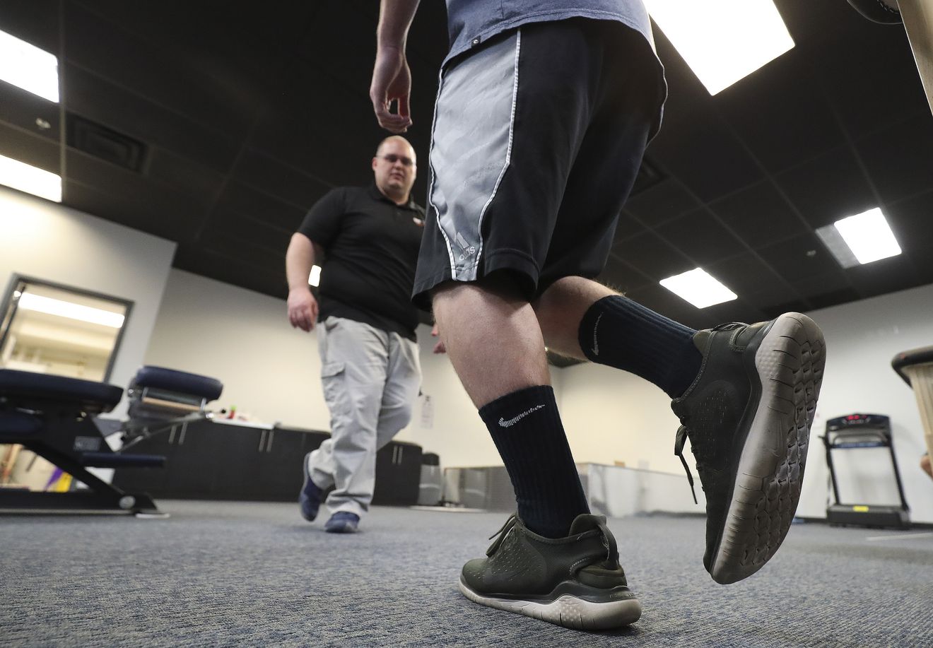 Dr. James Eagar, co-owner of the Training Room in American Fork, performs a physical therapy assessment on Hunter Corry on Tuesday, April 21, 2020. The Training Room has stayed open during COVID-19 pandemic. (Photo: Jeffrey D. Allred, KSL)
