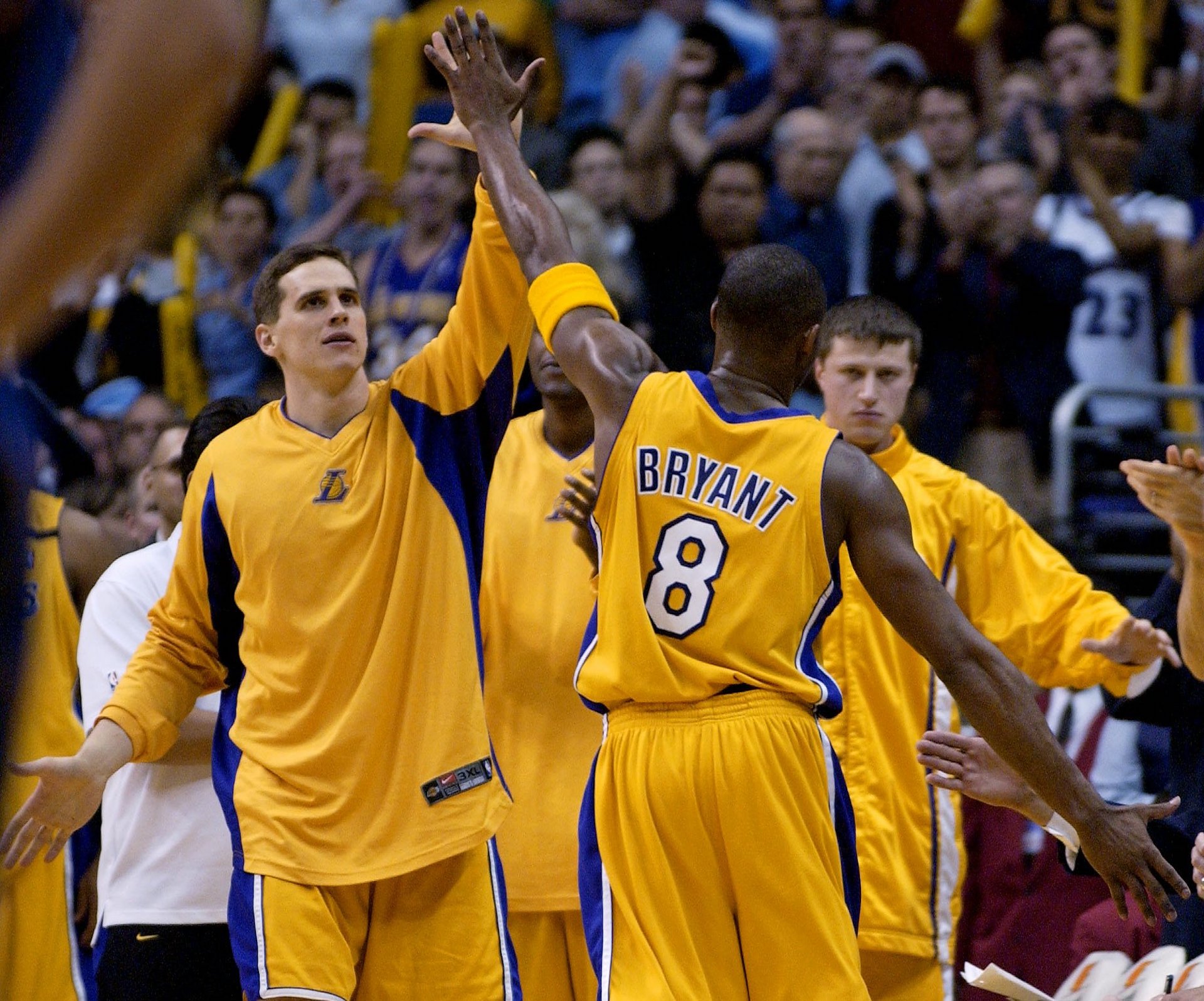 FILE - Los Angeles Lakers' Kobe Bryant, right, is congratulated by Mark Madsen, left, as he comes out of the game after scoring 55 points against the Washington Wizards on Friday, March 28, 2003, in Los Angeles. Playing against Michael Jordan for probably the final time, Kobe Bryant set a team record with 42 first-half points. The Lakers won 108-94. (AP Photo/Kevork Djansezian)
