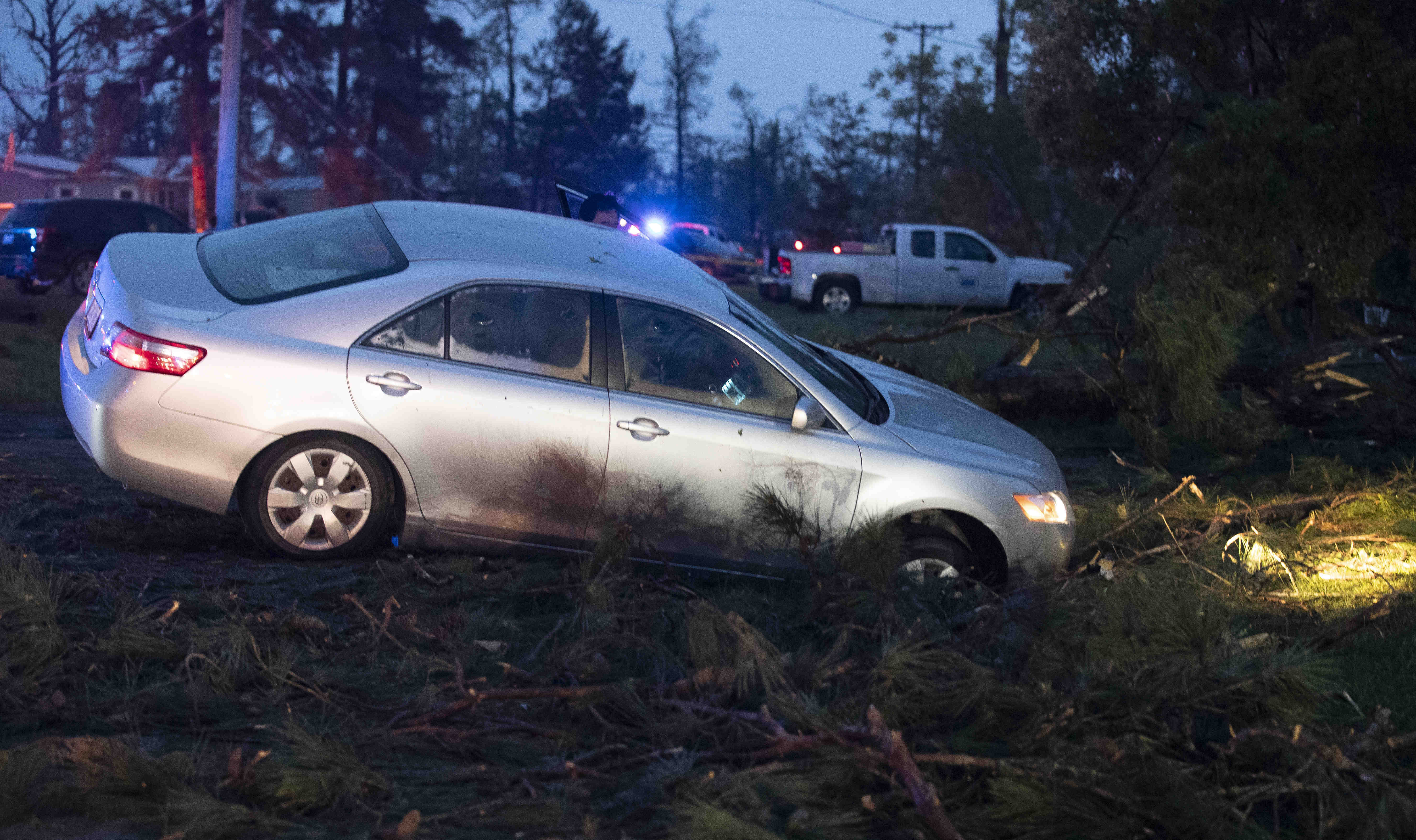 A car is seen in a ditch in Onalaska, Texas, after a tornado touched down in the area Wednesday, April 22, 2020. (Jason Fochtman/Houston Chronicle via AP)