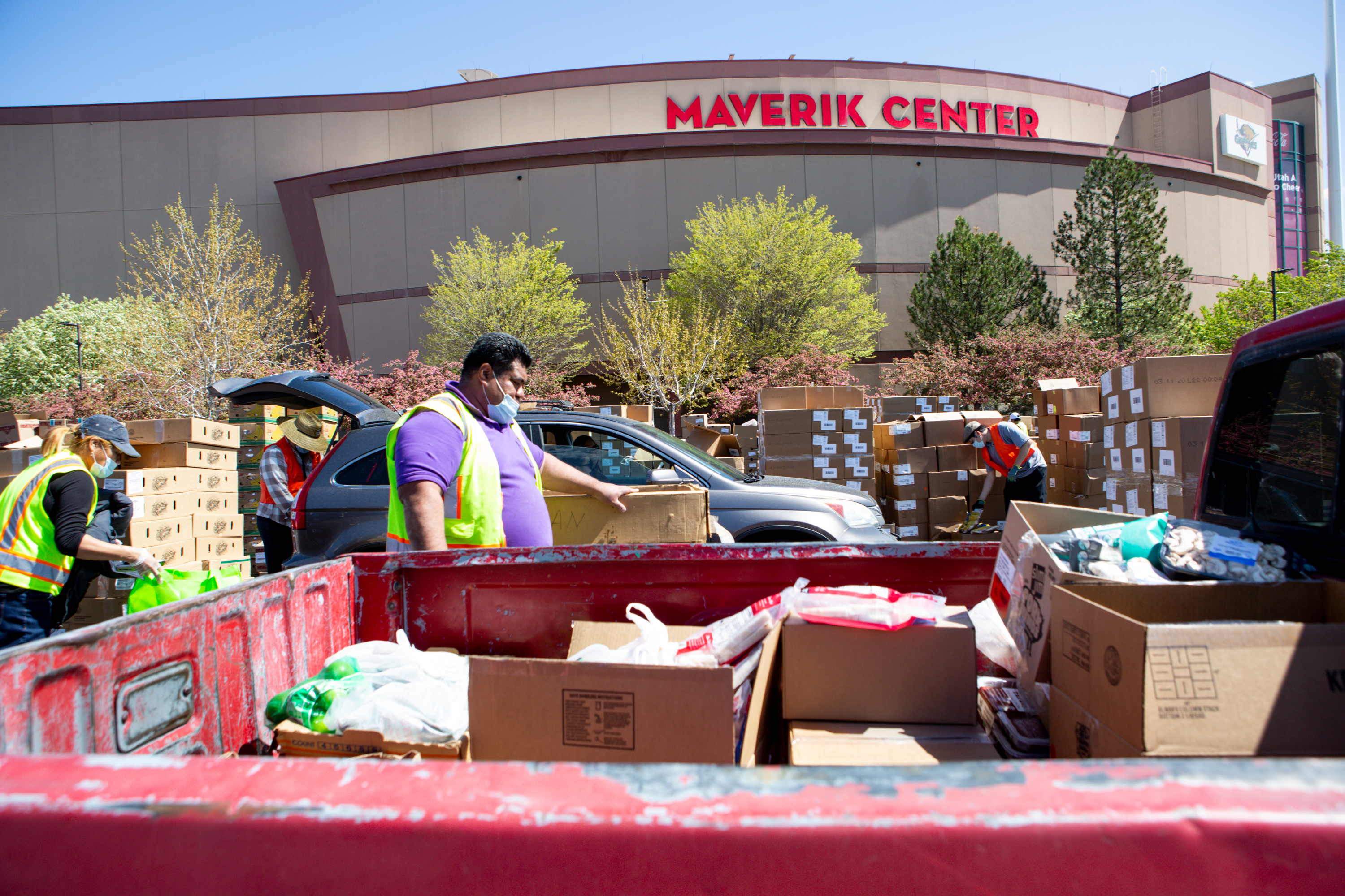Utah Food Bank volunteers and employees distribute groceries at the Maverik Center in West Valley City on Friday, April 24, 2020. Thousands of people waited for hours in a line that wound through the Maverick Center’s sprawling parking lot, spilling out onto 3100 South where it spanned almost a mile to the west. (Ivy Ceballo, KSL)